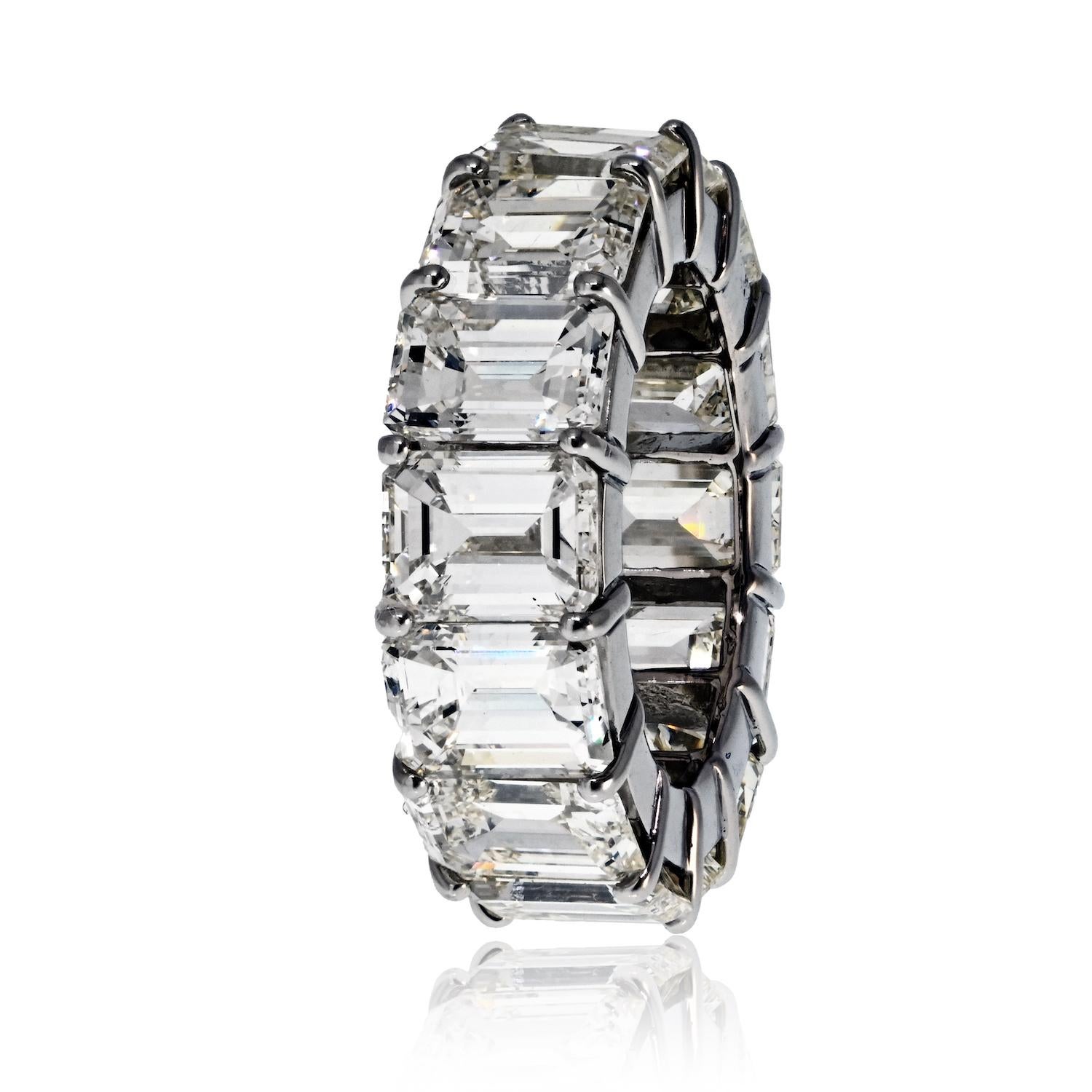 This breathtaking platinum eternity ring is a true masterpiece of fine jewelry craftsmanship, designed to captivate with its timeless elegance and remarkable sparkle. Featuring 14 stunning emerald-cut diamonds, the ring boasts an impressive total