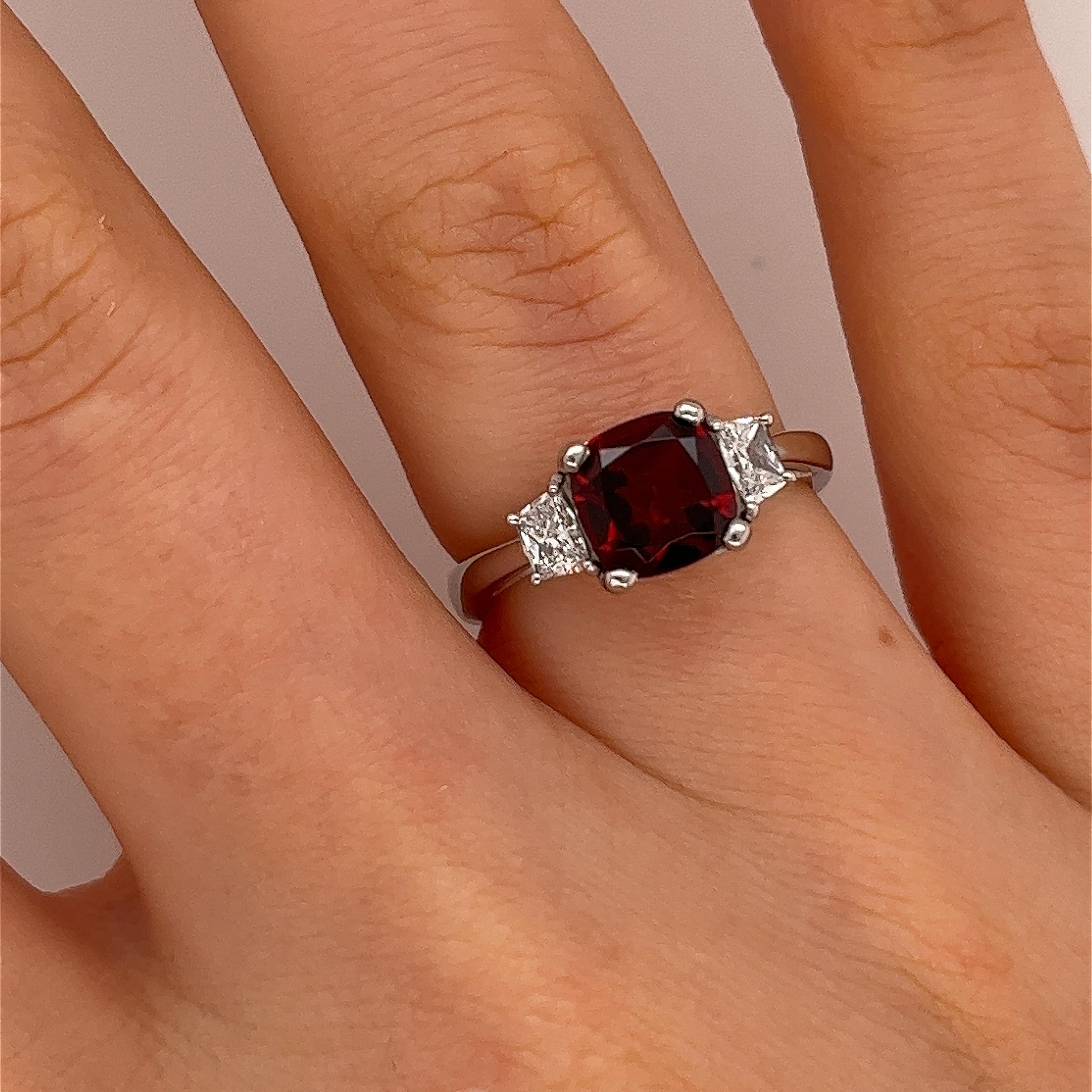 An elegant and unique 1.88ct garnet and diamond ring, 
set with 2 tapered natural diamonds 0.33ct,
in a platinum beautiful setting.

Width of Band: 3.05mm
Width of Head: 7.47mm
Length of Head: 13.53mm
Total Weight: 6.10g
Ring Size: M
SMS9233