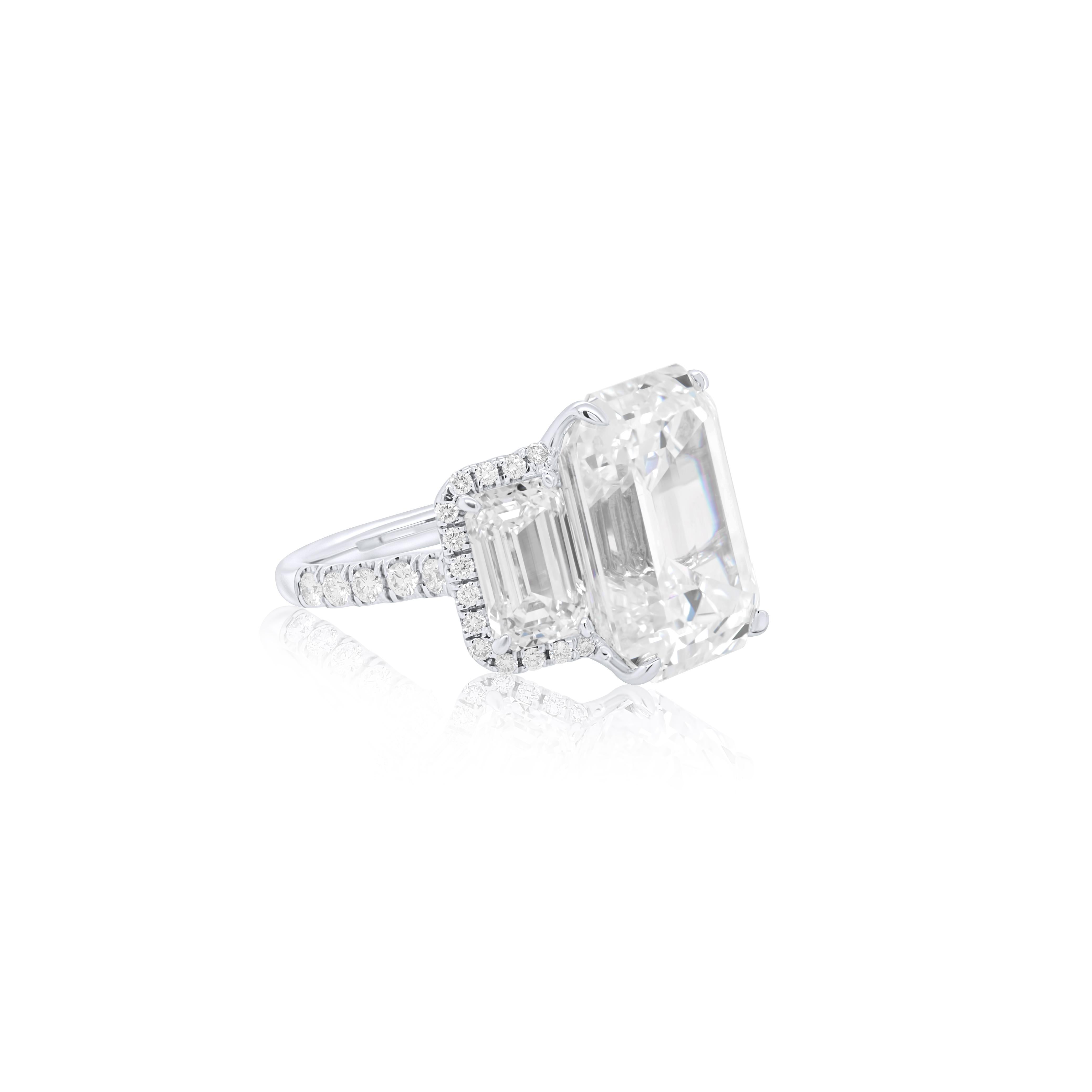 Exquisite three stone diamond engagement ring features three emerald cut diamonds, the center stone is 12.49 Carat I color VVS2 in Clarity Emerald Cut Diamond set with Two GIA Certified Emerald Cut Diamonds on Each Side 4.50 Carats total diamond