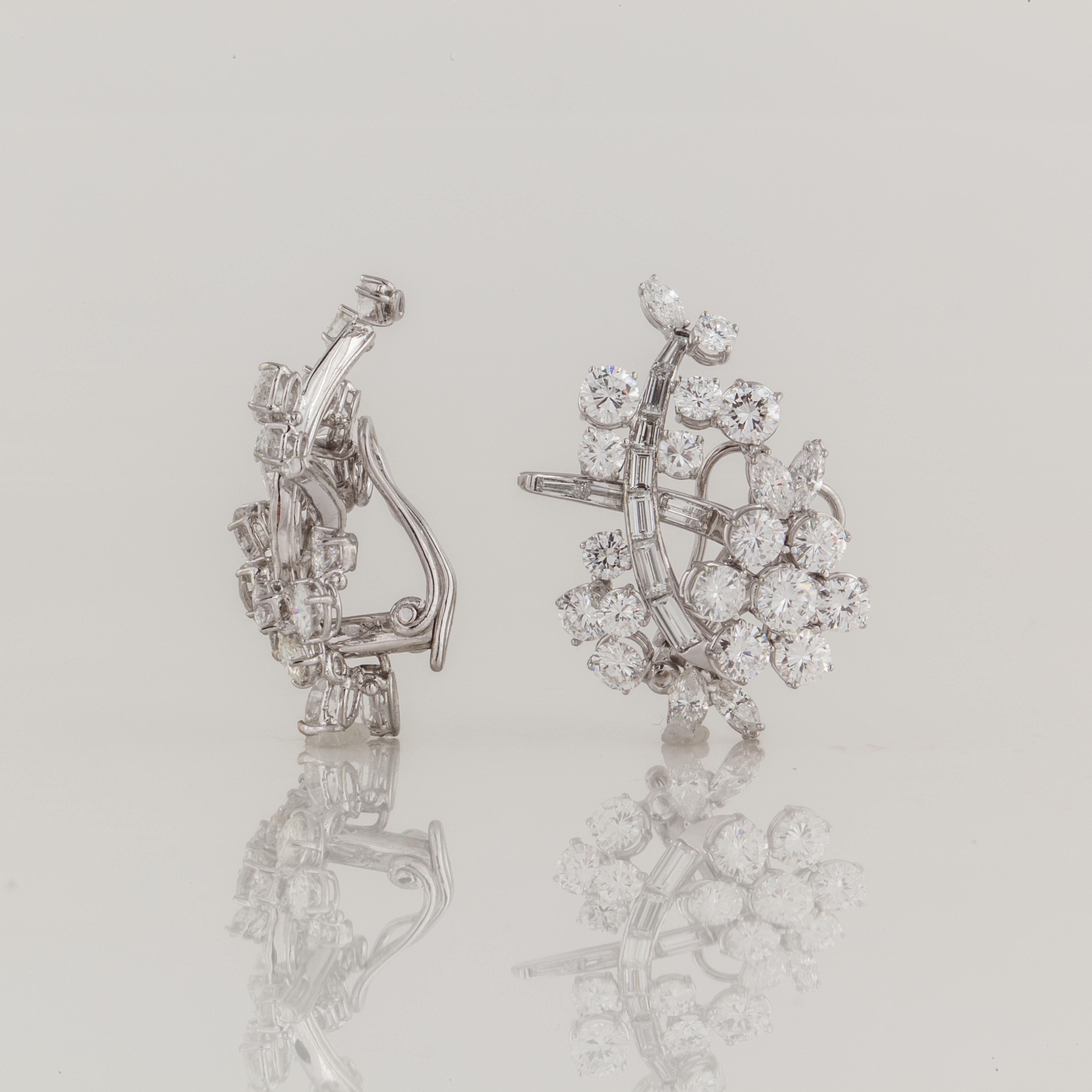 Platinum diamond cluster earrings with 18K white gold lever backs.  There are round, marquise and baguette diamonds that total 8.50 carats, G-H color and VVS-VS clarity.  They measure 1 1/4 inches long and 7/8 inches wide.  They are clip backs.
	
