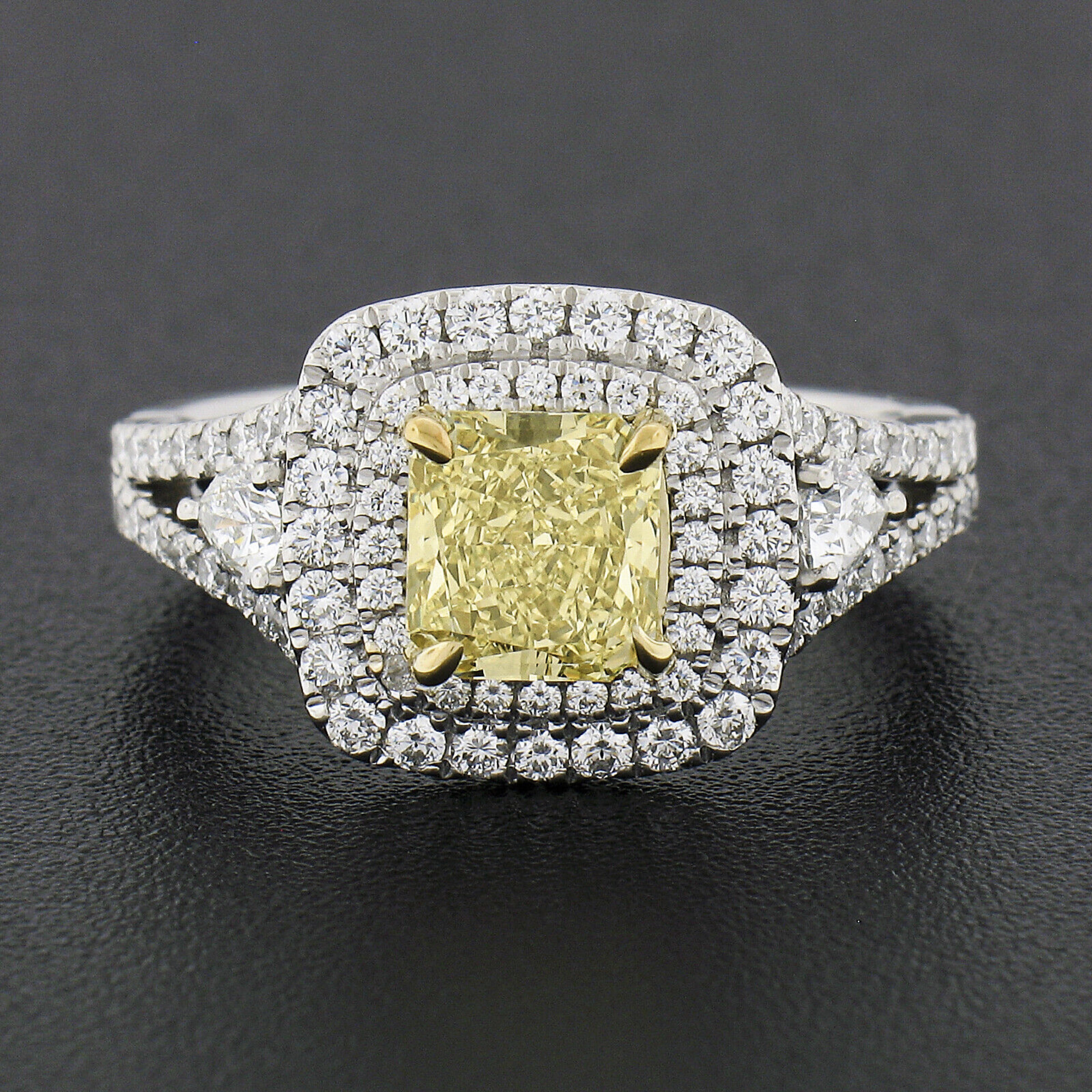 This truly breathtaking and very well made diamond engagement or cocktail ring is crafted in platinum and solid 18k yellow gold. The ring features a beautiful, GIA certified, fancy yellow diamond neatly prong set in the yellow gold center basket,