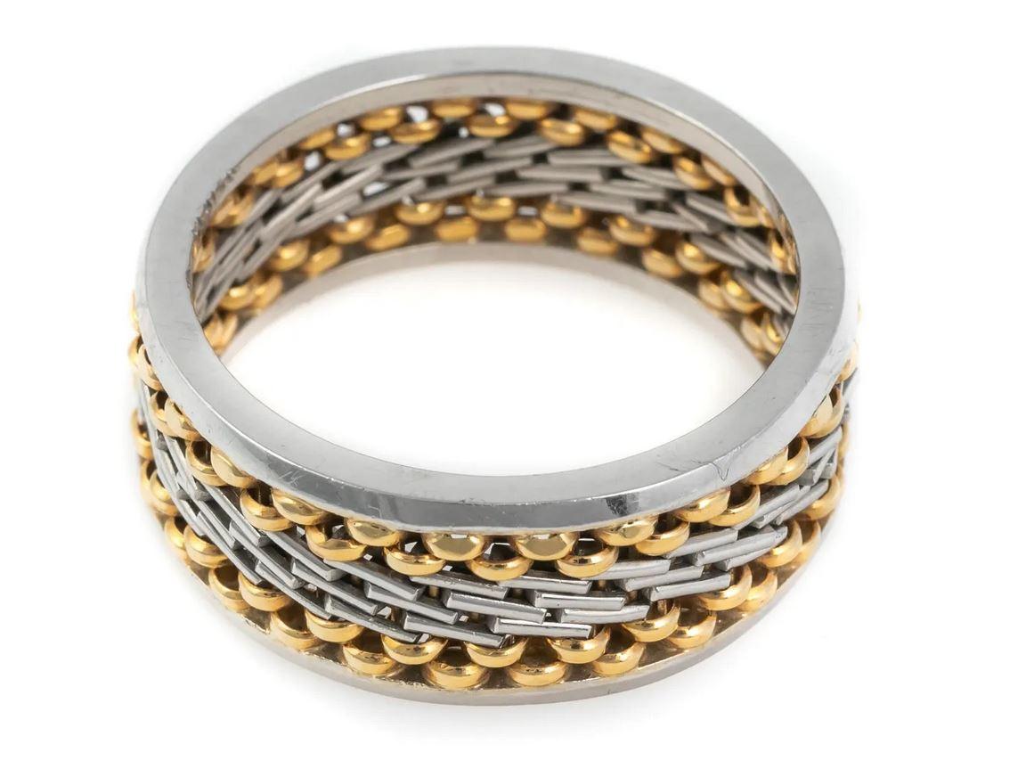 Men's designer style wedding band ring. Crafted platinum with 18K gold accents. Features a basket weave pattern with two tone design. Designer signature. Marked PLAT and 18K and with an illegible designer mark

Size 13. Total weight approximately