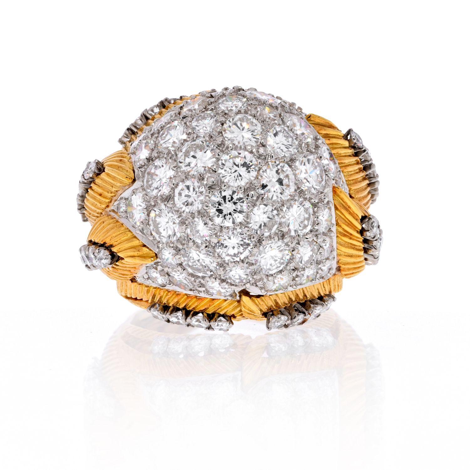 Diamond dome ring in platinum and yellow gold crafted with 8.50cts in round cut high quality diamonds, that are framed a top a textured gold shank. The setting is further decorated with fluted texture and round cut accent diamonds. 
Total carat