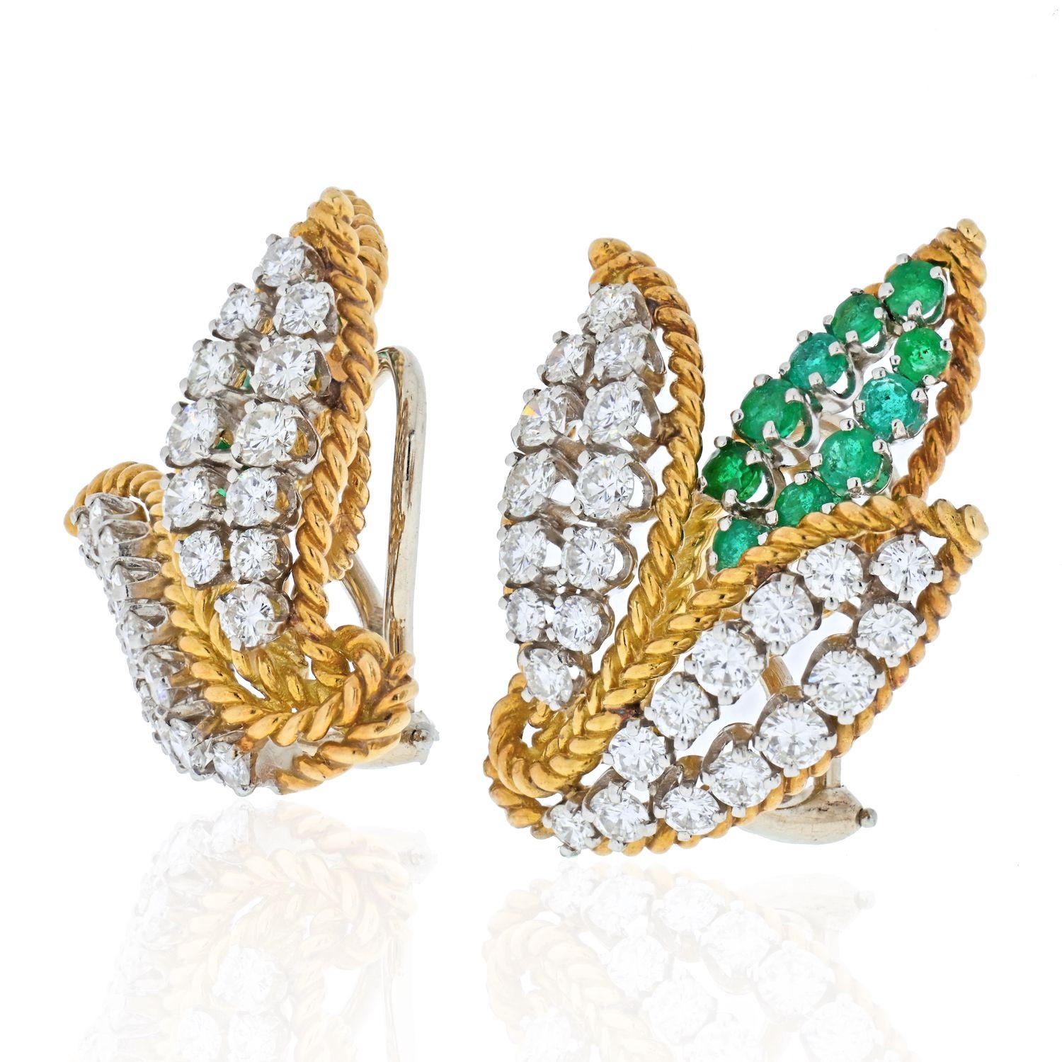 Set with approximately 1.70 carat of green emeralds, highlighted by about 1.30 cts in diamonds, these gold clipback earrings date from the 1970s. Outlined in gold rope-twist, the high relief curling triple leaf motifs feature round cut white