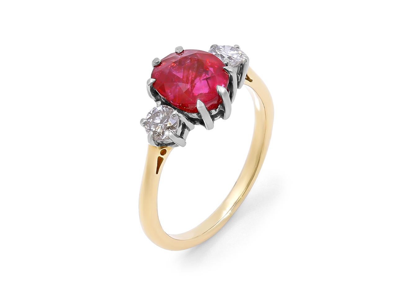 This stunning 3.59 carat oval Burma ruby and two sparkling round diamonds, totaling 0.50 carats, are set in platinum on a 18k yellow gold shank. The ruby is AGL certified with no signs of heating.