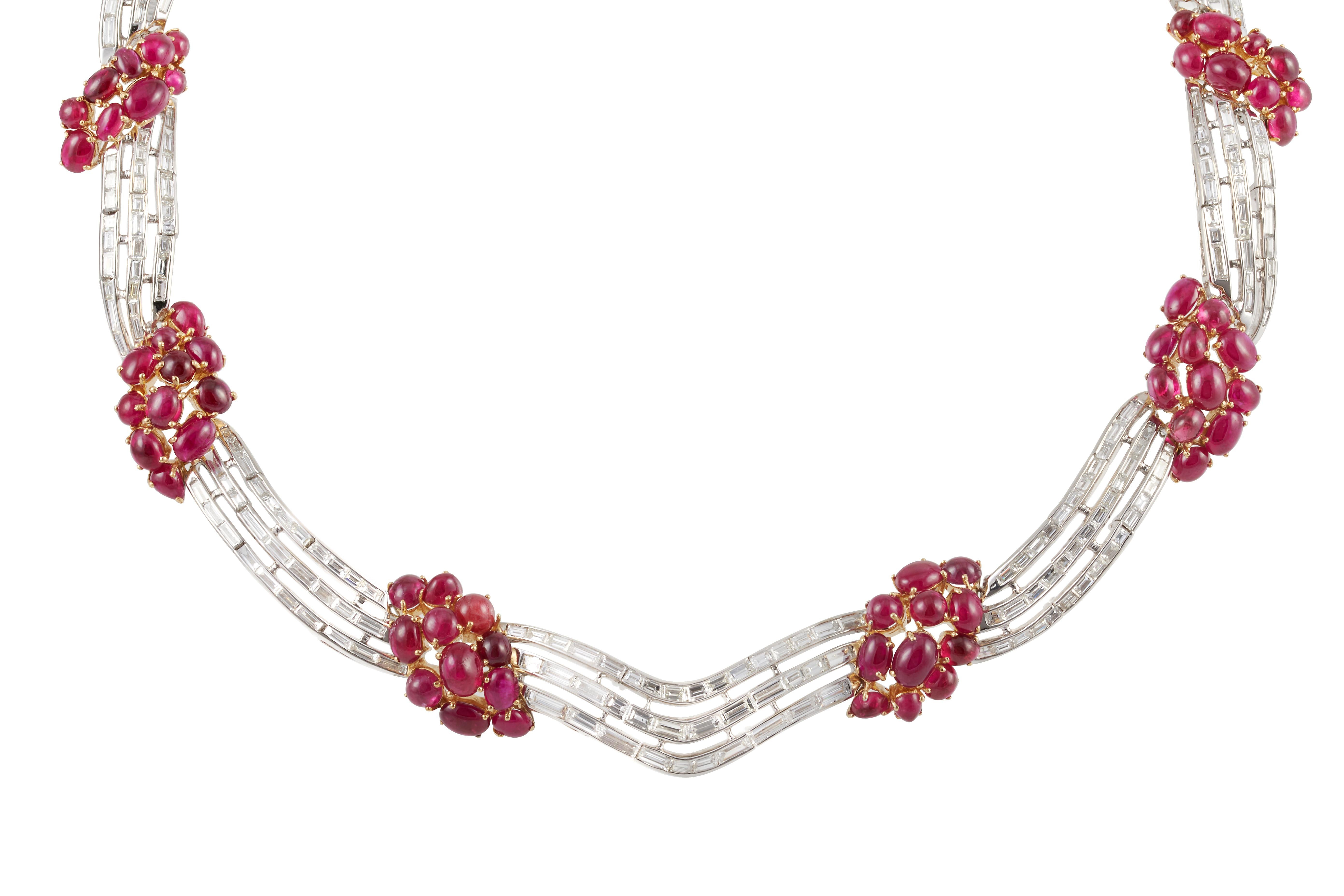 A platinum and 18-karat yellow gold necklace with groups of oval cabochon rubies and rows of baguette diamonds. There are 70 rubies that total about 67.48 carats. There are 259 baguette diamonds that weight around 20.00 carats and have a F-G color