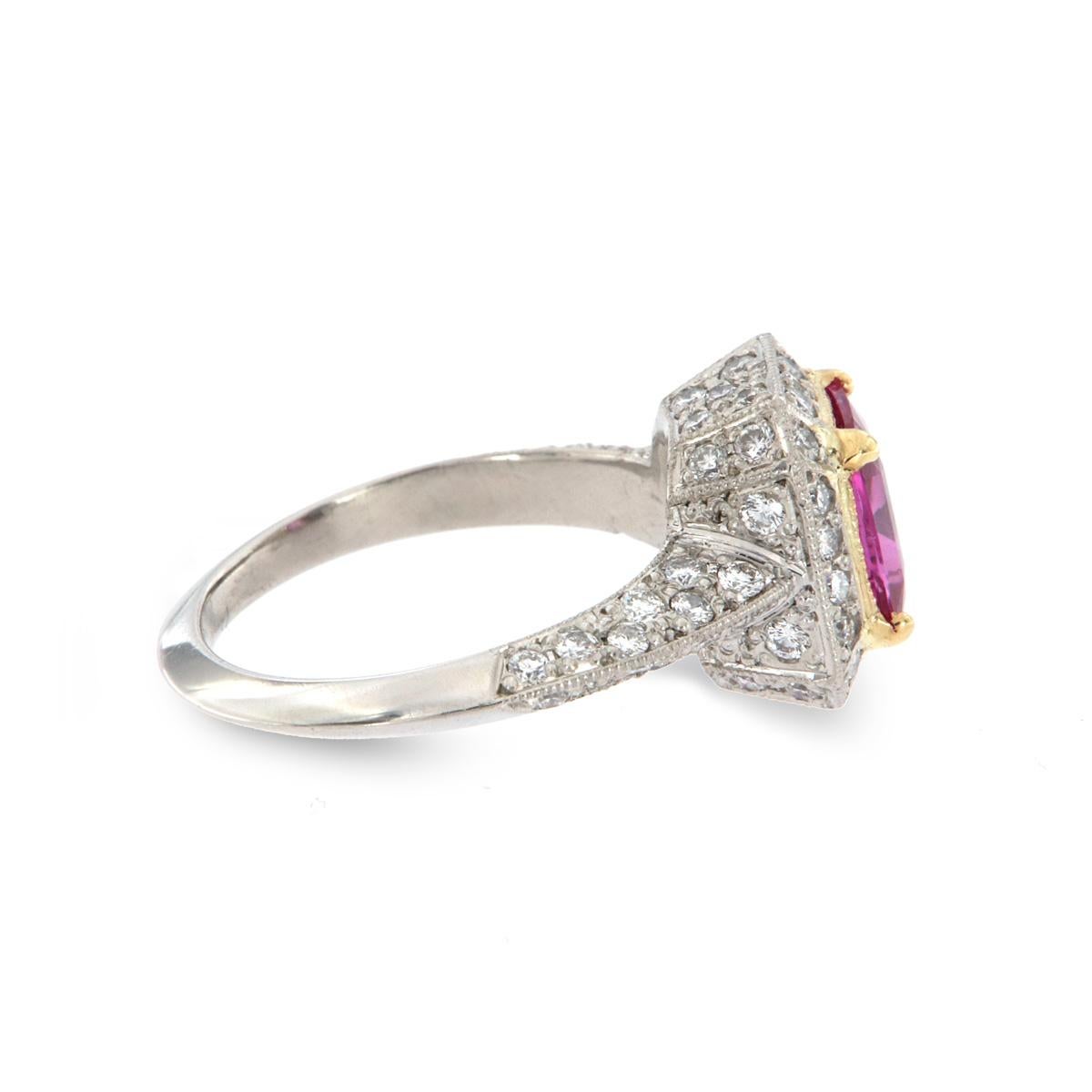 This unique handcrafted ring showcases a 1.83-carat cushion shape Hot Purple Pink Sapphire GIA Certificate: 2203223798 sets in Platinum and 18k yellow gold halo style ring. The Sapphire accents seventy-two round diamonds in total carat weight of