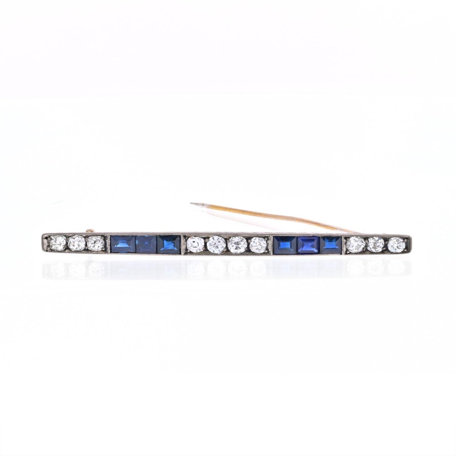 This is a lovely diamond and sapphire brooch crafted in platinum and 18k yellow gold. Set with old cut diamonds, and french cut sapphires. 
Length: 3 inches, 
Width: 0.25 inch.
Fatsens with a yellow gold pin.