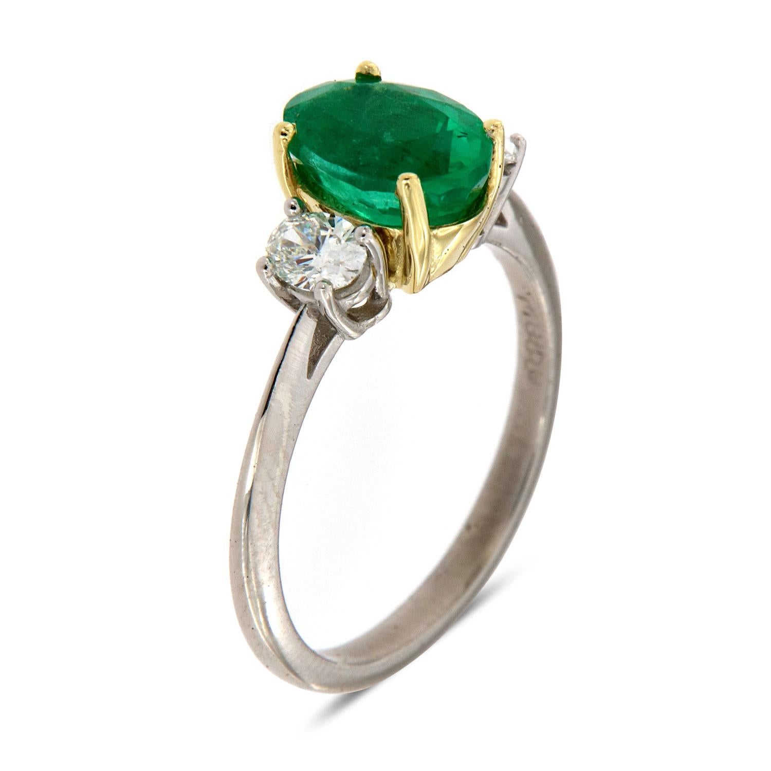 This Classic Three-stone ring features a 1.86 Carat Ethiopian Oval-shaped emerald flanked by two perfectly matched Oval-shaped natural diamonds in the total weight of 0.37 carat. Our clients love Ethiopian emerald due to their exceptional luster and