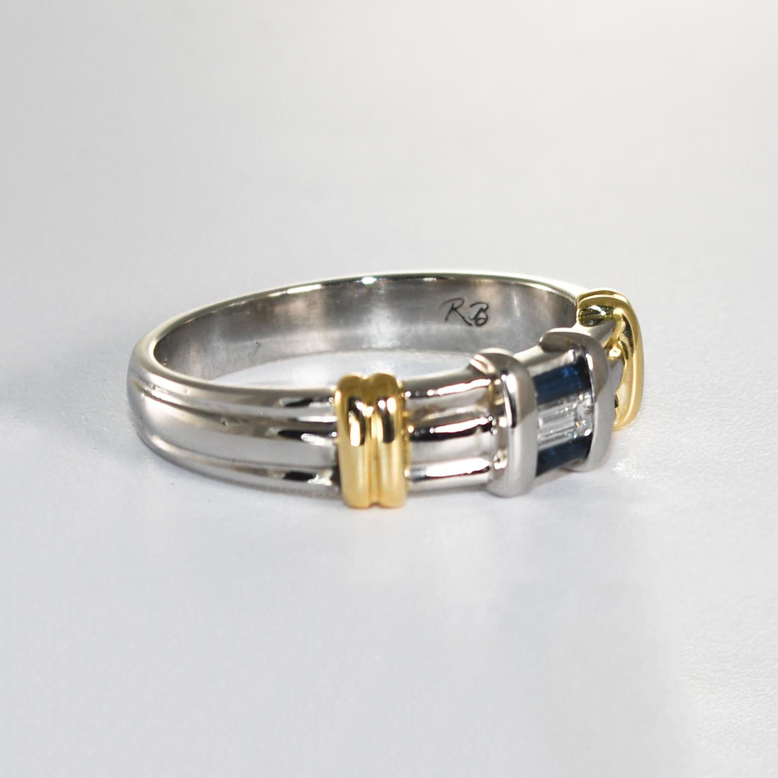 Men's platinum and gold wedding band with diamonds and sapphires.
Stamped Plat, 18k and tests 96% platinum.
Ring weight is 10 grams.
There is a .10 carat baguette cut diamond in the middle and two small sapphires on the sides.
The top of the ring