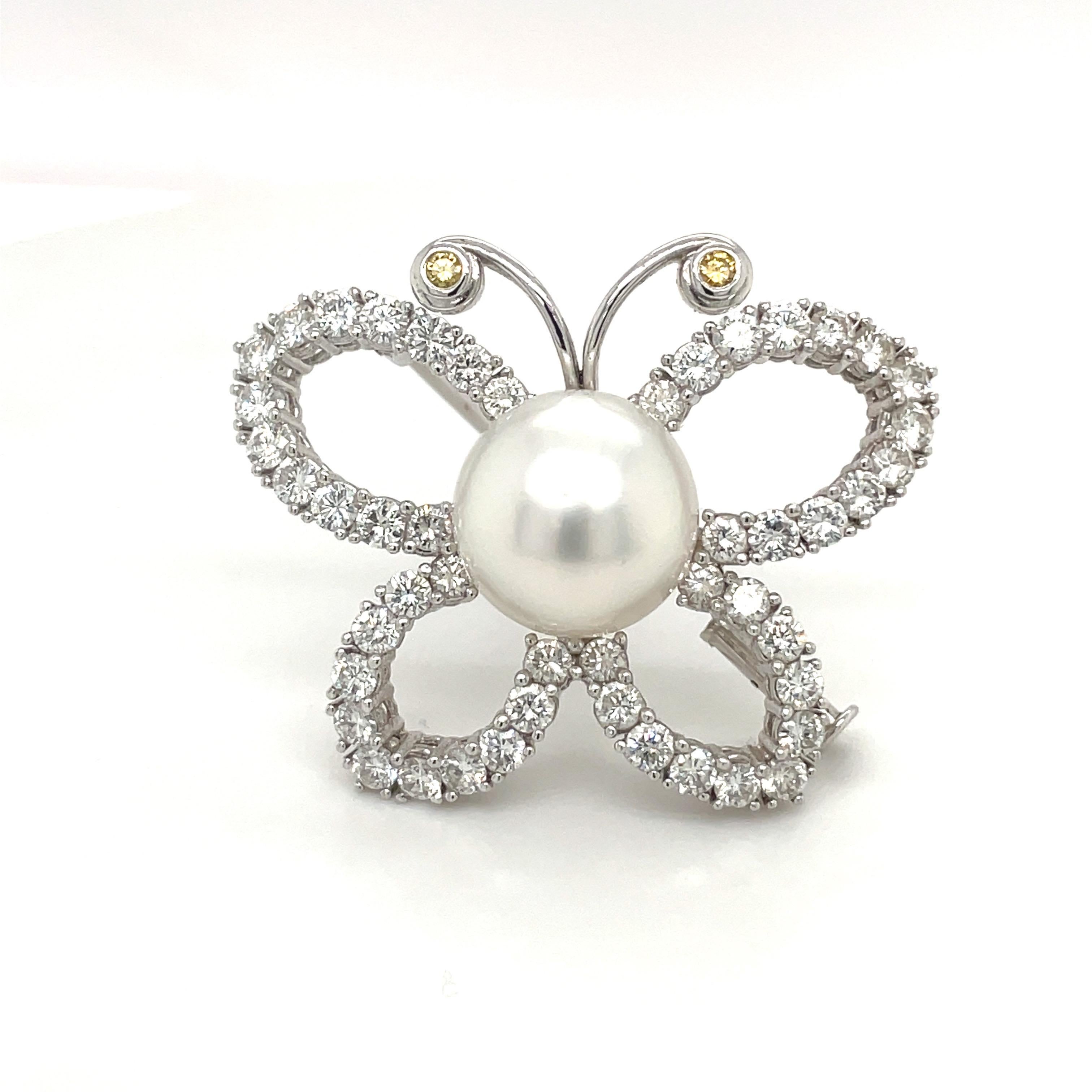 This lovely Butterfly brooch is prong set with round brilliant Diamonds. The 2 antennae have bezel set yellow sapphires. The center of the brooch is a 13 mm South Sea Pearl. The butterfly measures 1.50