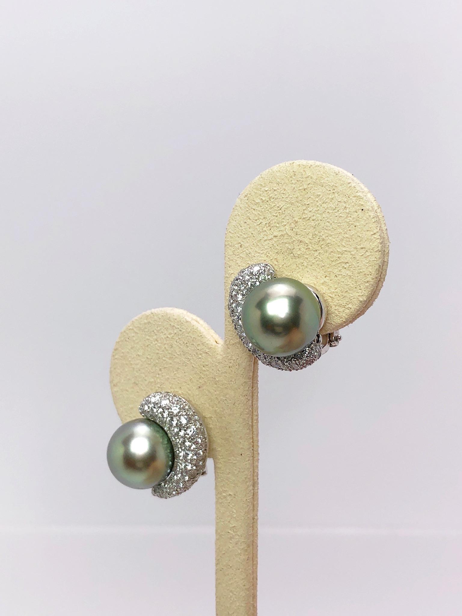 Crescent shaped earrings designed with pave Diamonds and  beautiful Green Tahitian Pearls.These earrings have an adjustable post suitable for pierced and non pierced ears. Approximately 5/8