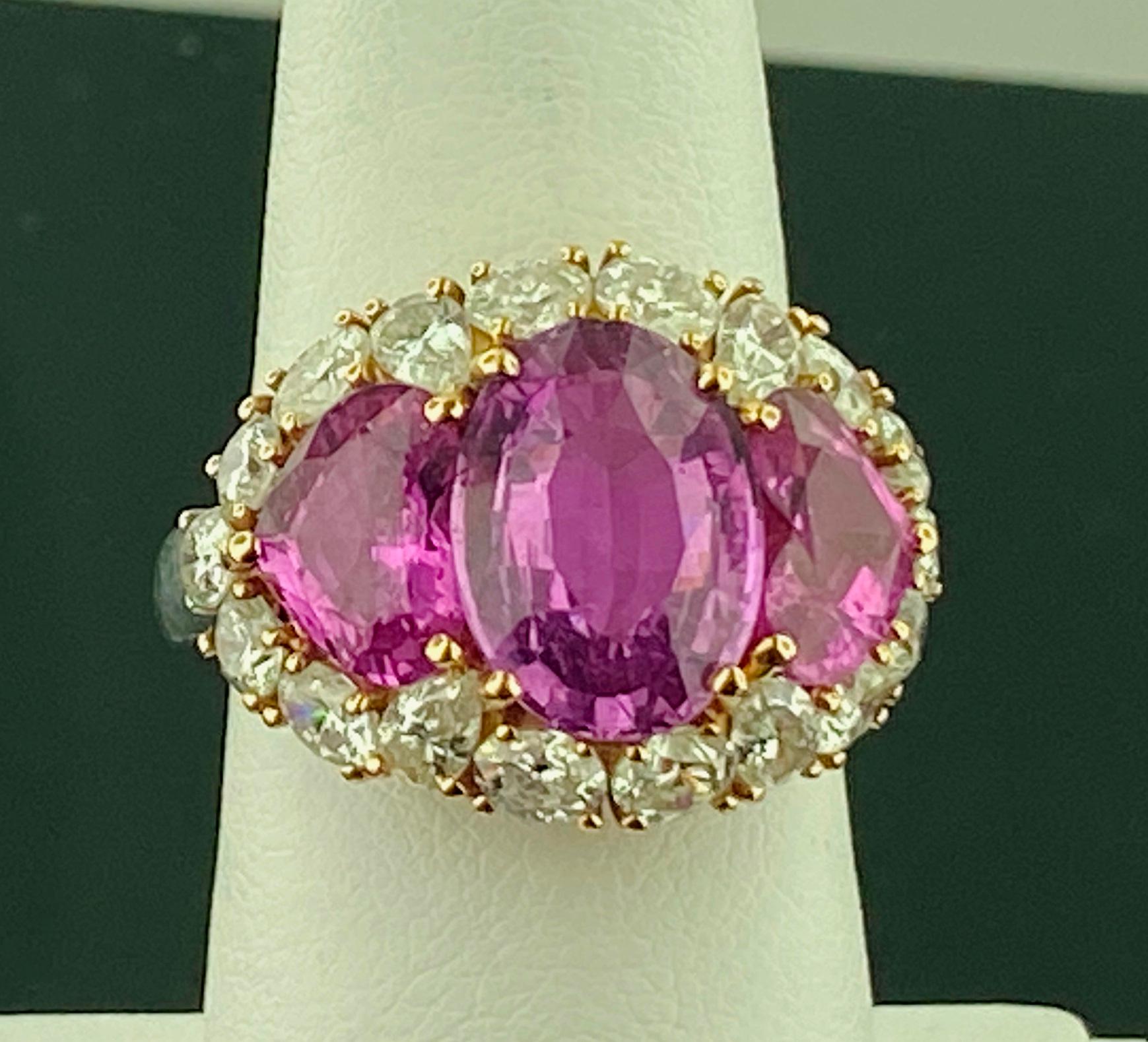 Set in Platinum and 18 karat white gold are three Pink Sapphires.  The center is an 8.75 carat Oval Cut Pink Sapphire with 2 Heart Shaped Pink Sapphires on the side with a total weight of 4.00 carats.  Surrounding the three sapphires are 18 Round