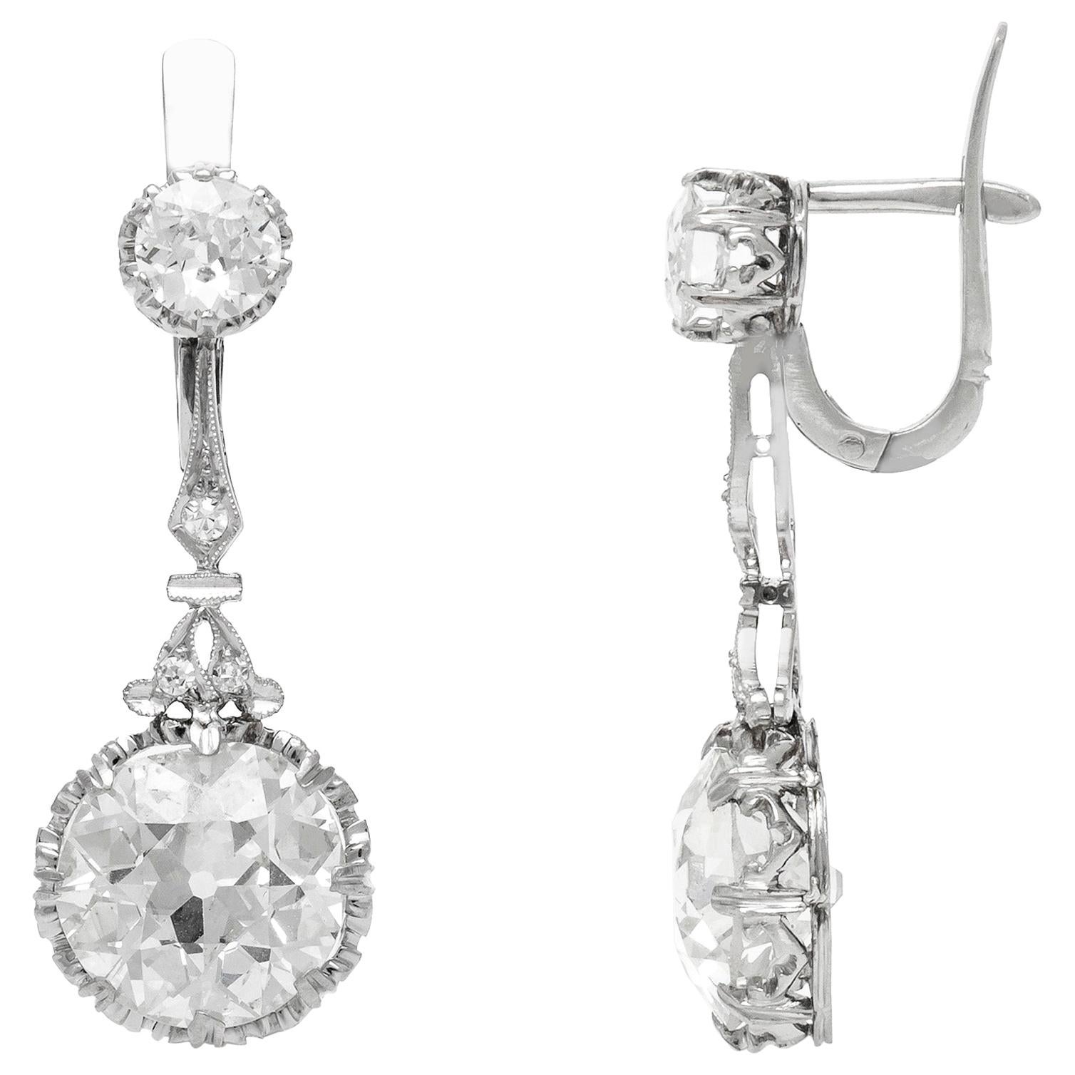 Finely crafted in platinum with two Old European cut bottom diamonds, one weighing 3.97 carats and the other weighing 3.80 carats.
J-K color, VS2-SI1 clarity.
The earrings feature two top diamonds weighing approximately a total of 1.20 carats.
Art