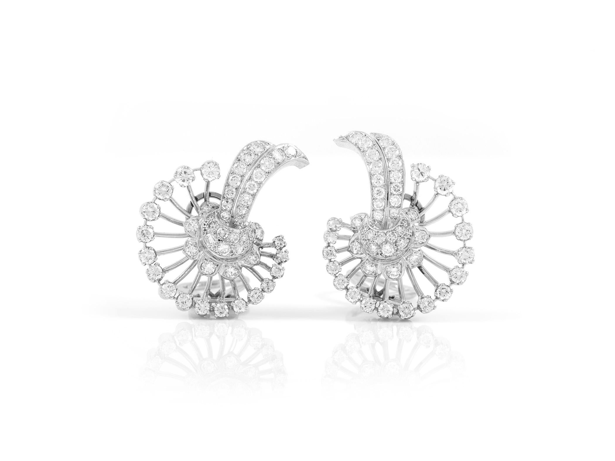 The earrings are finely crafted in platinum with diamonds weighing approximately total of 7.00 carat.