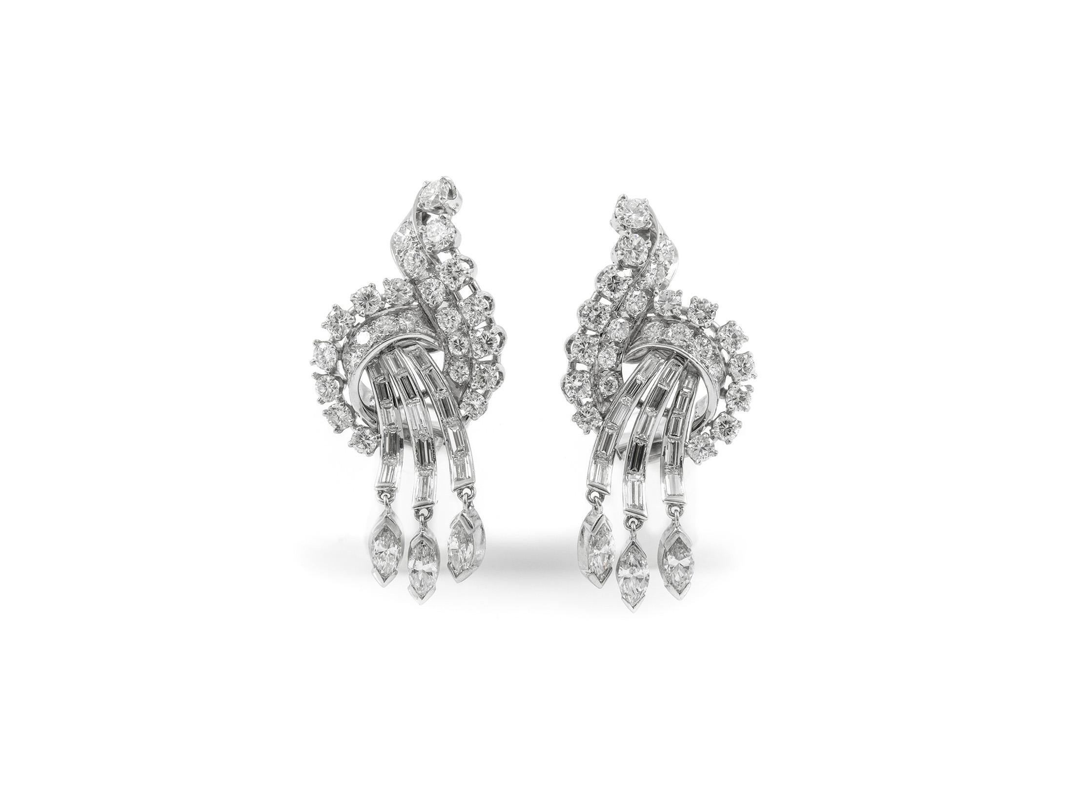 The earrings are finely crafted in platinum with round-, marquise-, and baguette-cut diamonds weighing a total of approximately 6.00 carats.