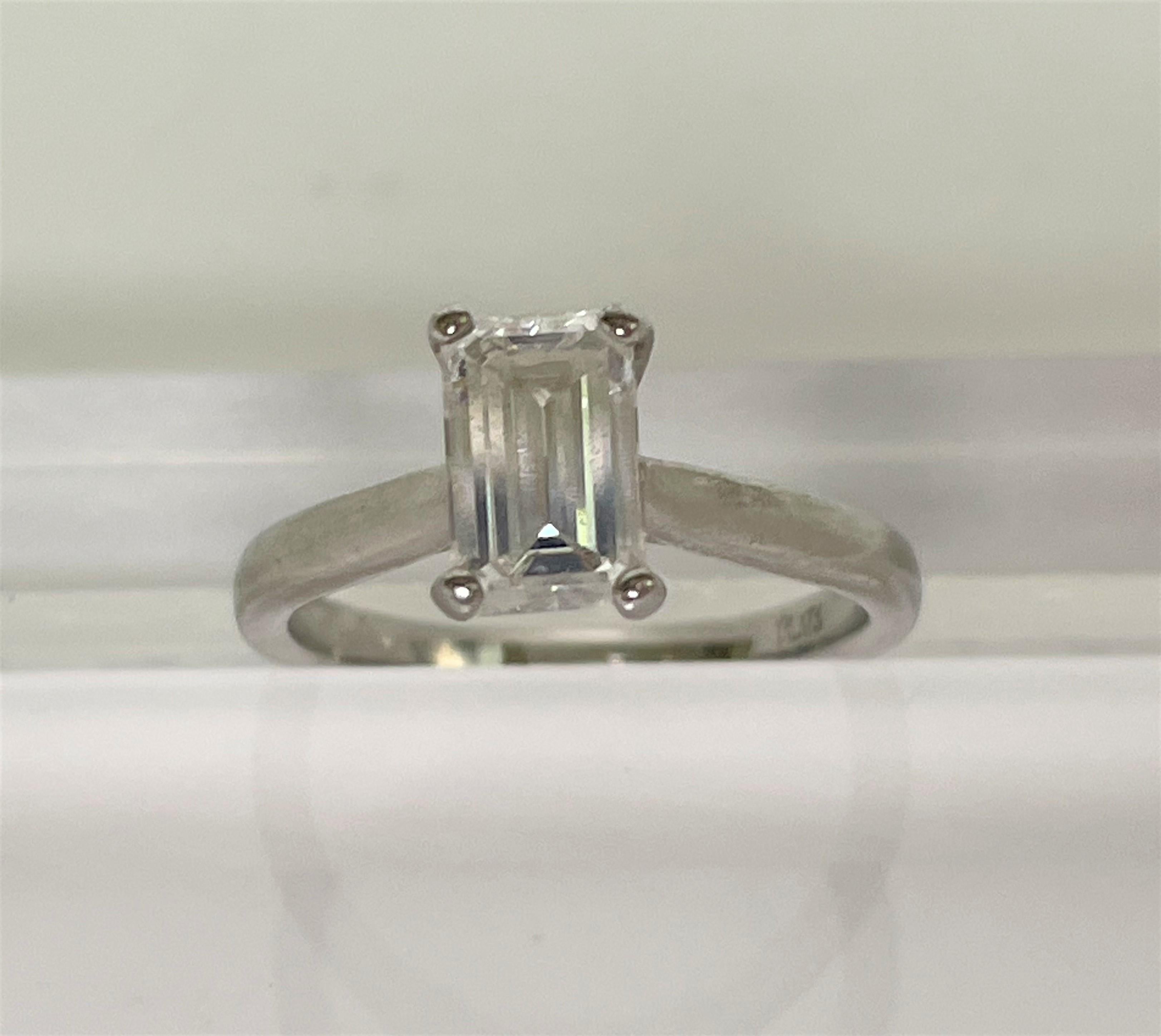 Beautifully simple!  This ring shines from across the room!
Platinum band with four prongs, approximately 2.0-2.5mm wide
Approximately 1 carat emerald cut diamond, approximately 7.55mm X 4.72mm X 3.6mm.   
H-I color, SI clarity
Size 5
Stamped 