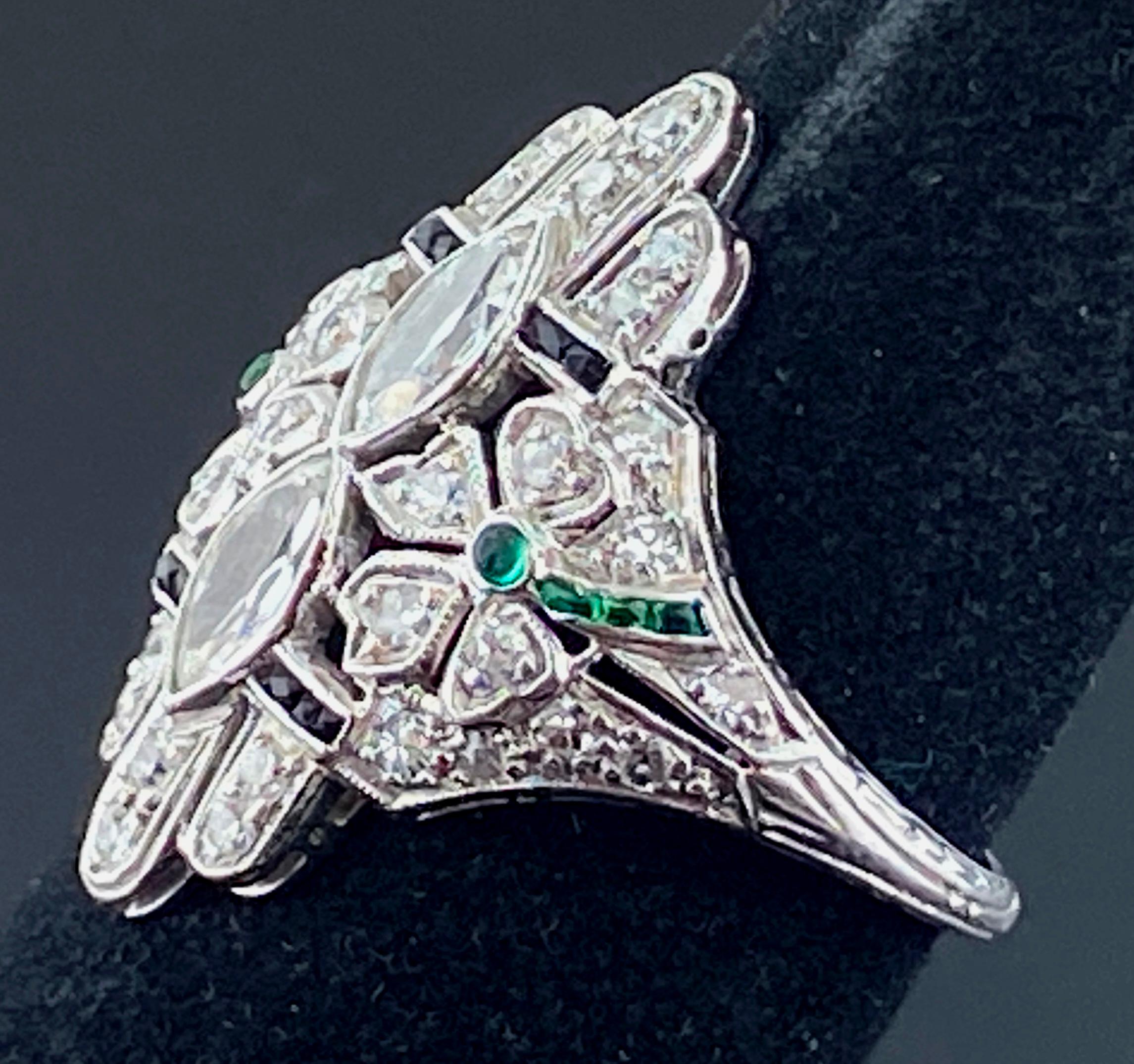 Set in Platinum, in the center, are two Marquise cut Diamonds weighing 0.66 carats in total, Color: I-J, Clarity: VS-2, plus 36 Round Brilliant cut diamonds weighing 0.70 carats, 1.36 carats total diamond weight,  enhanced with two Round Cut and 6