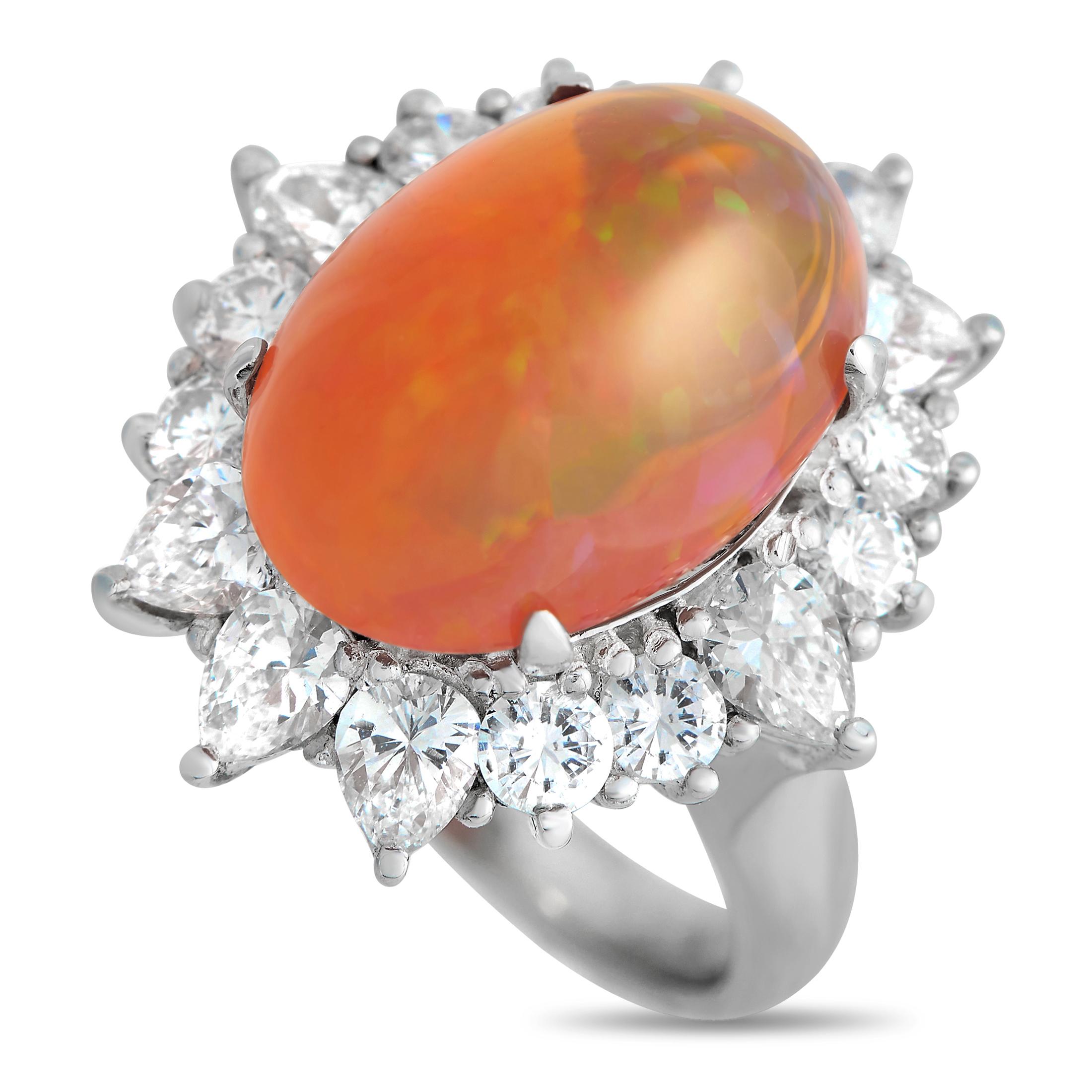 A breathtaking orange-hued 7.19 carat opal is surrounded by a halo of diamonds totaling 2.03 carats on this exquisite luxury ring. Bold and incredibly impactful, it features a shimmering platinum setting with a 4mm wide band and a 12mm top