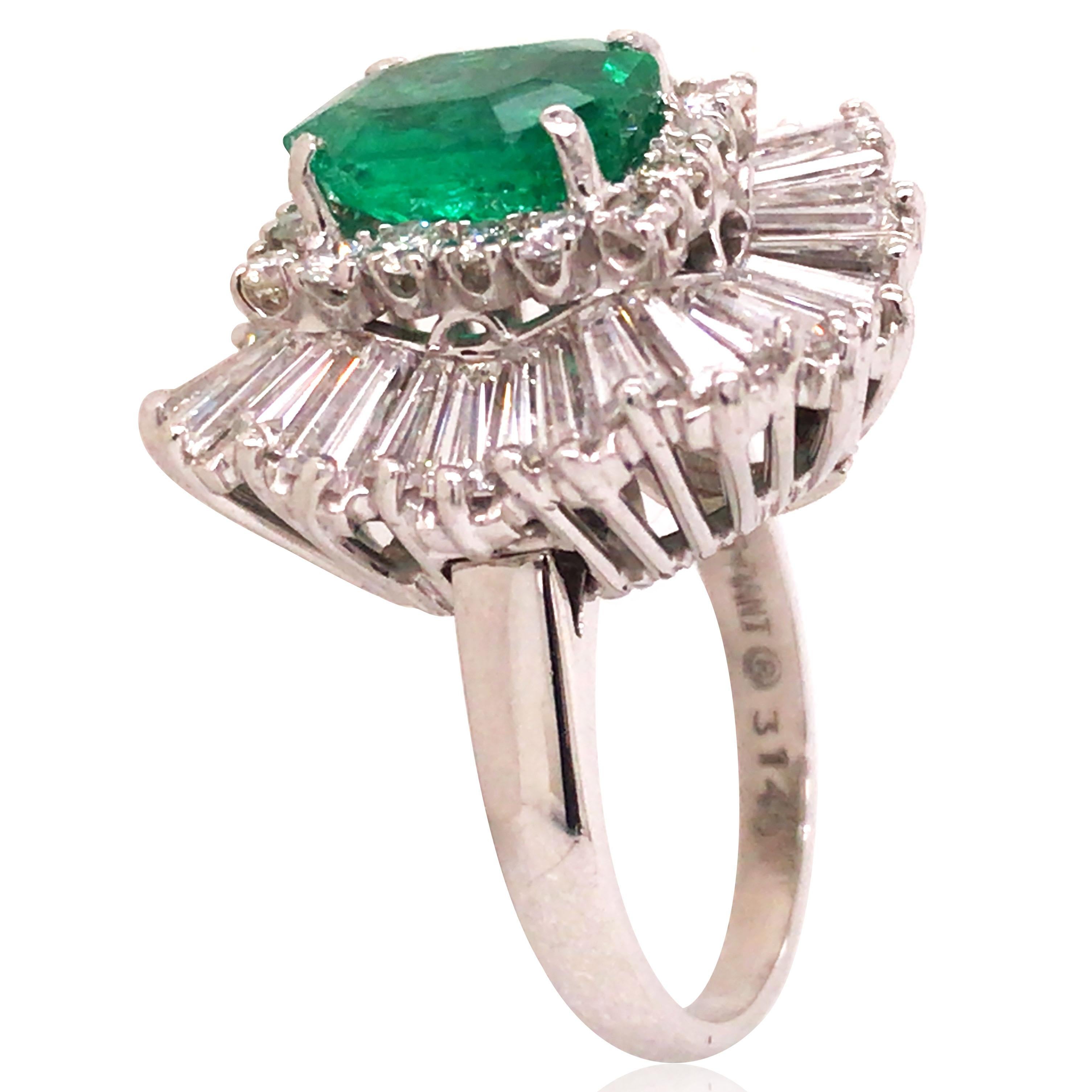 2.08ct octagonal step cut Colombia emerald is surrounded by tapered baguette cut diamonds, total approx. 2.52ct, G-H/VS-SI, round brilliant-cut diamonds total approx. 0.48ct, G-H/VS-SI. Ring size: 5. Accompanied by an AGL report stating that the