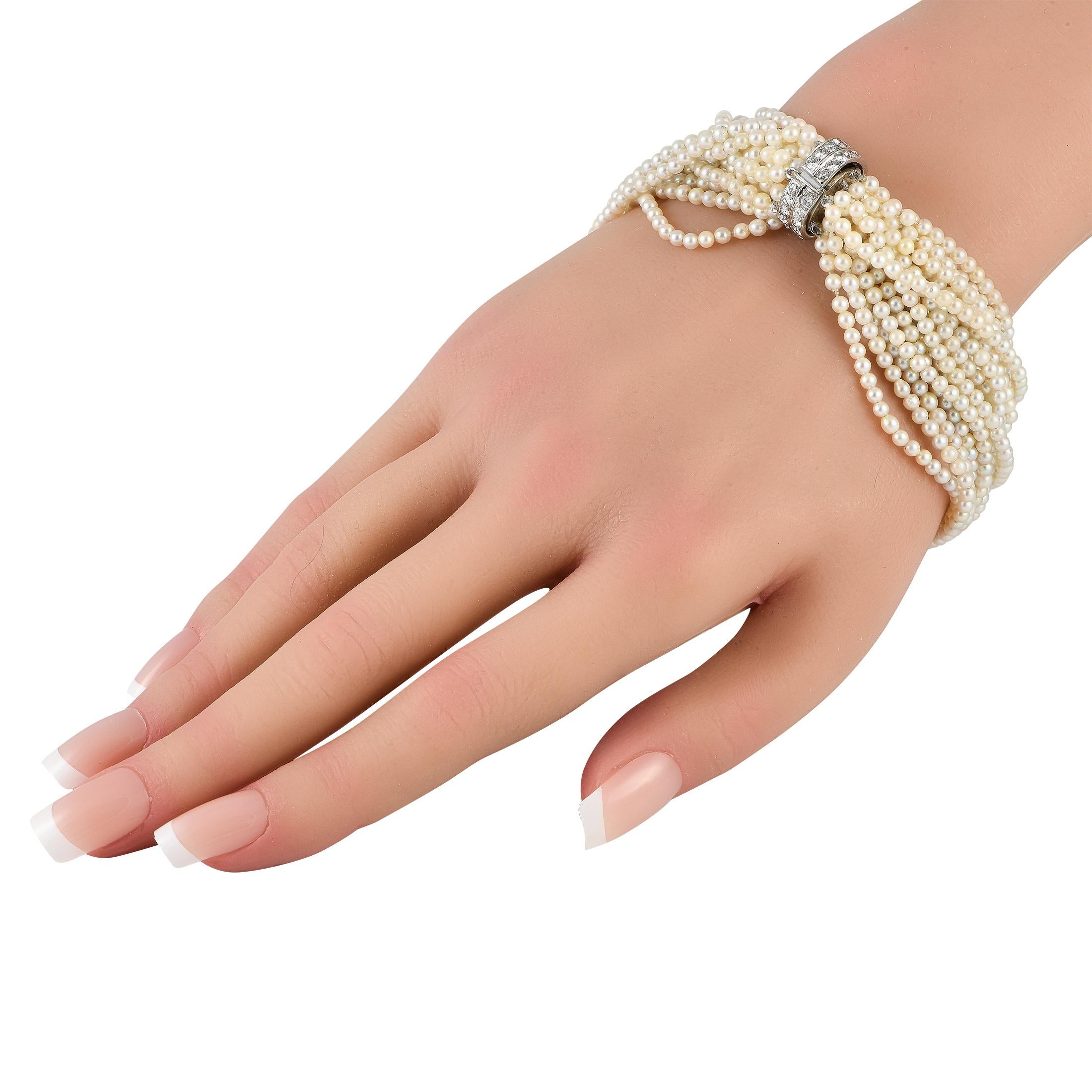 As classic as it gets. This beauty features multiple strands of petite pearls ready to adorn your wrist with chic elegance. The lustrous strands are gathered by a diamond-studded platinum clasp that doubles as the bracelet's centerpiece.This