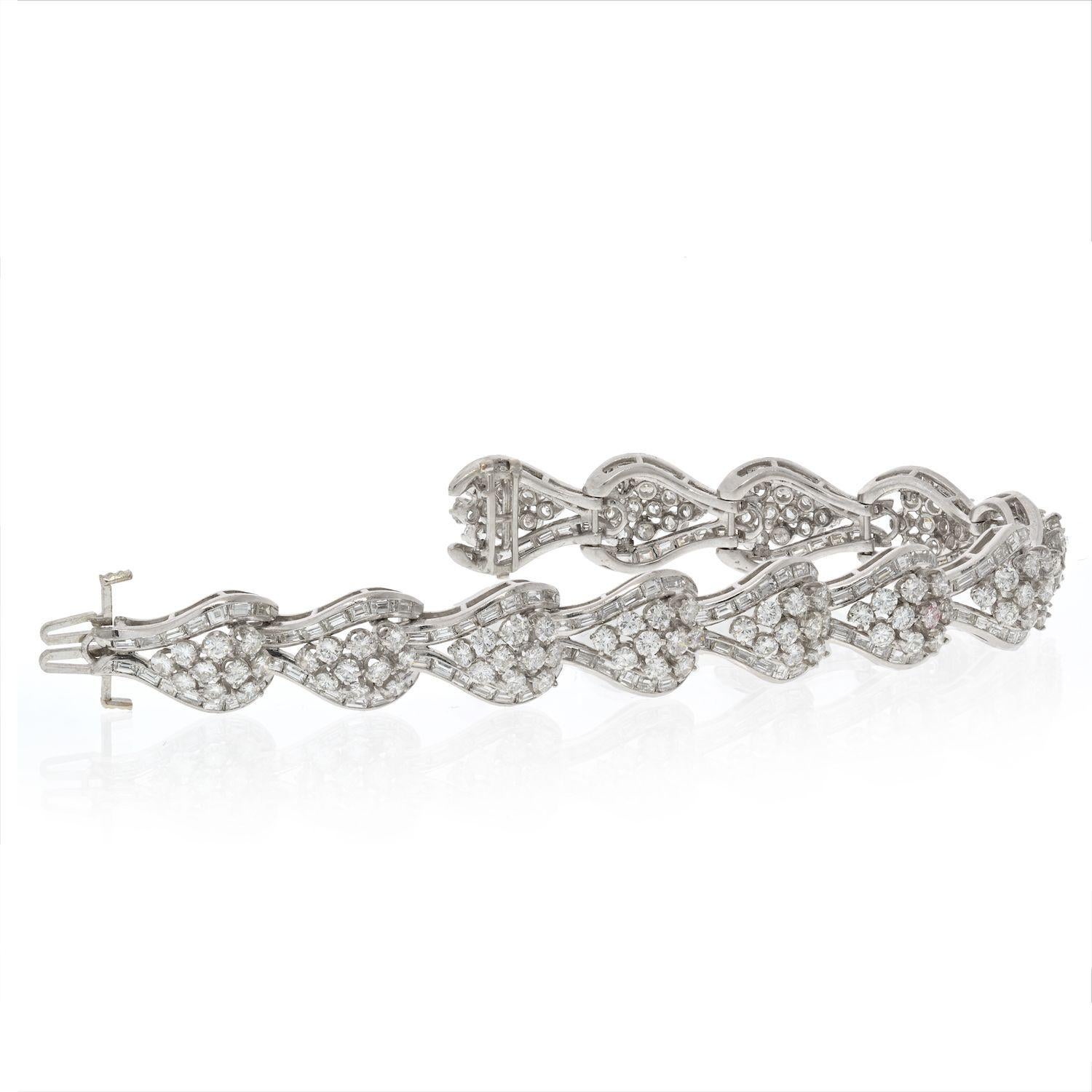 Crafted in 1950's this platinum diamond bracelet is a pleasure to own and to wear. It is made of durable platinum, mounted with gleaming round brilliant cut diamonds of clean white clarity, framed with slick baguette cuts. 
This bracelet has a