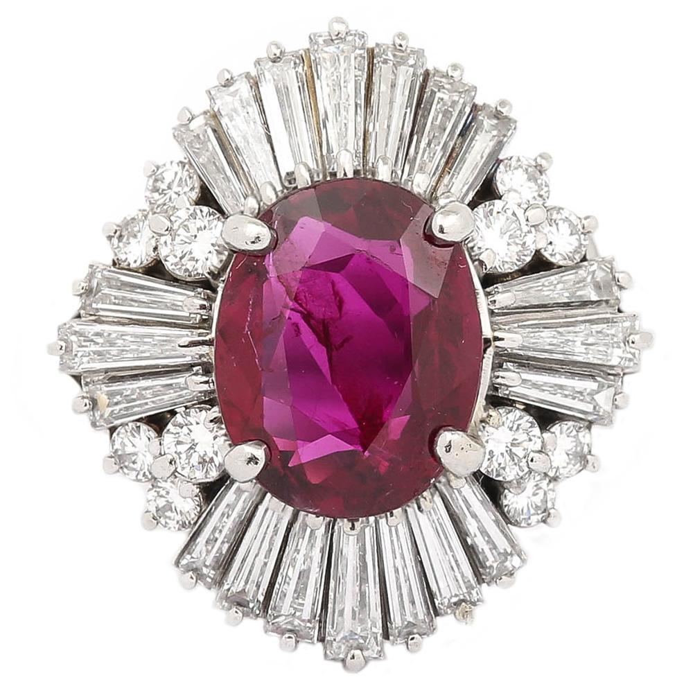 A striking platinum, natural ruby and baguette and round brilliant diamond ‘ballerina’ cluster ring. This natural ruby ring is estimated at 2.24 carat, surmounted by an estimated 1.40 carats of kite shaped baguette diamonds with 0.60 carats of round