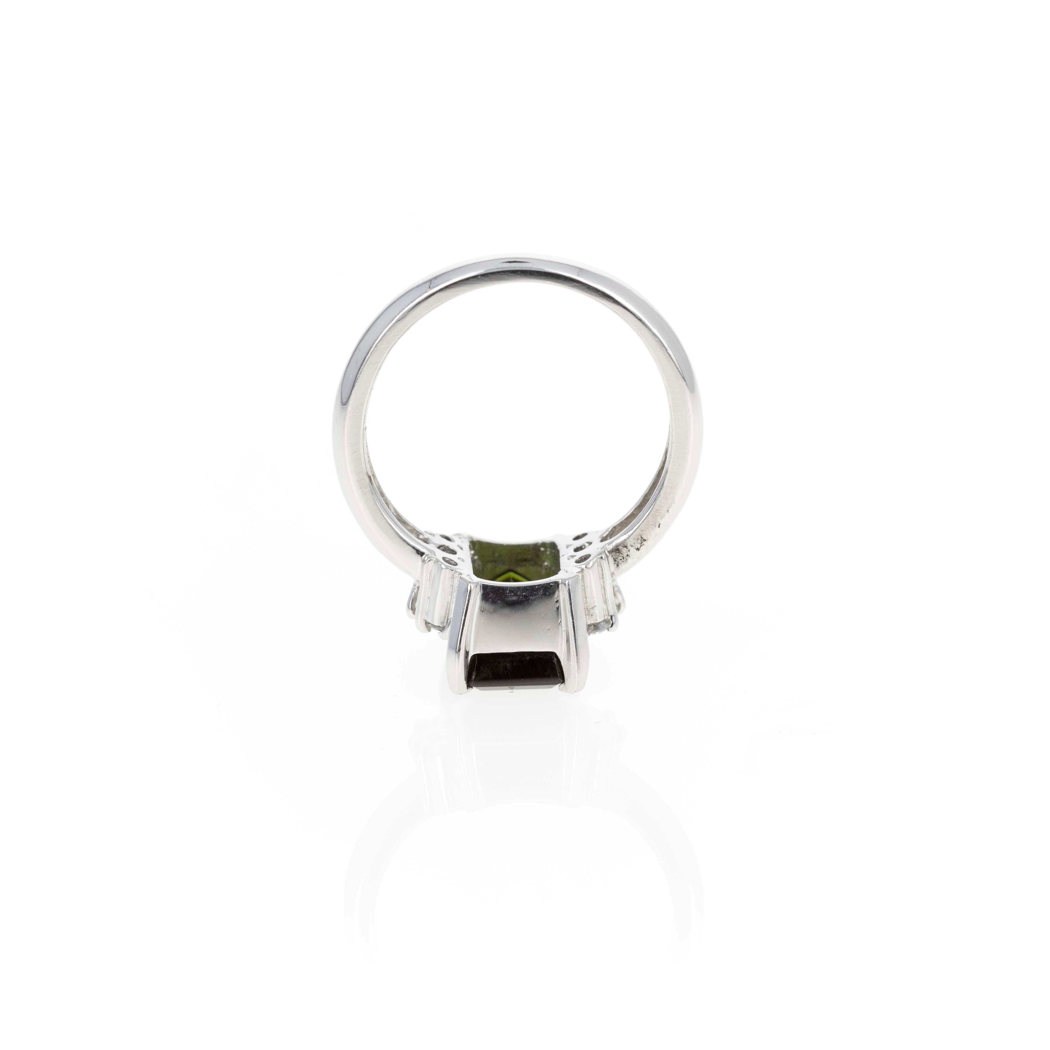 Era: New
Composition: Platinum
Primary Stone: Emerald Cut Green Tourmaline
Carat Weight: 2.26 Carats
Accent Stone: Six Round Brilliant Diamonds
Carat Weight: 0.15 Carats in Total
Color/Clarity: G-H / SI1-VS2
Ring Size: 5.5
Ring Weight: 6.3