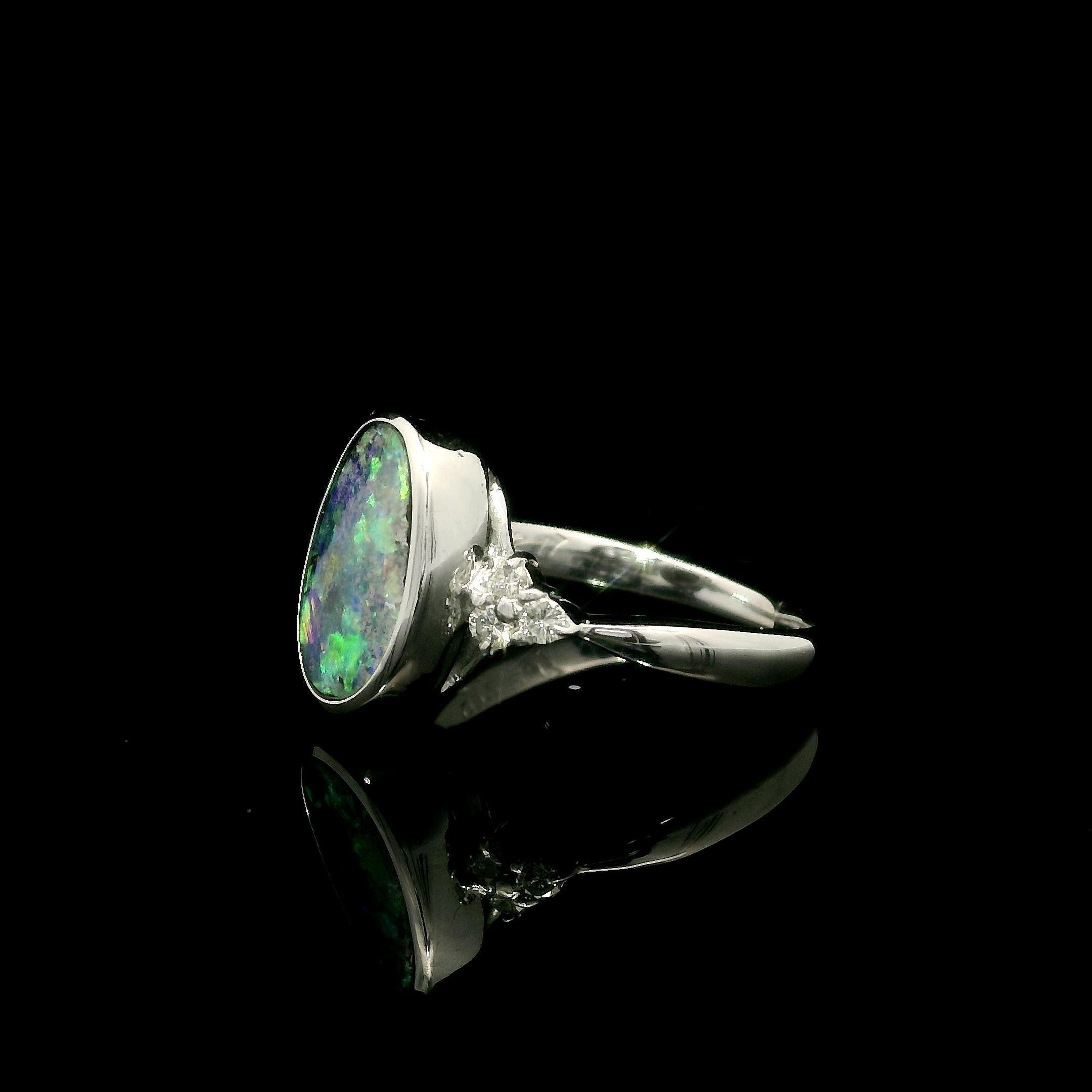 --Stone(s):--
(1) Natural Genuine Boulder Opal - Oval Cut - Bezel Set - Black Color w/ Green, Orange & Blue Play of Color - 10.8x7mm - 2.17ct (exact)
(6) Natural Genuine Diamonds - Round Brilliant Cut - Prong Set - Nice Brilliant White Color -
