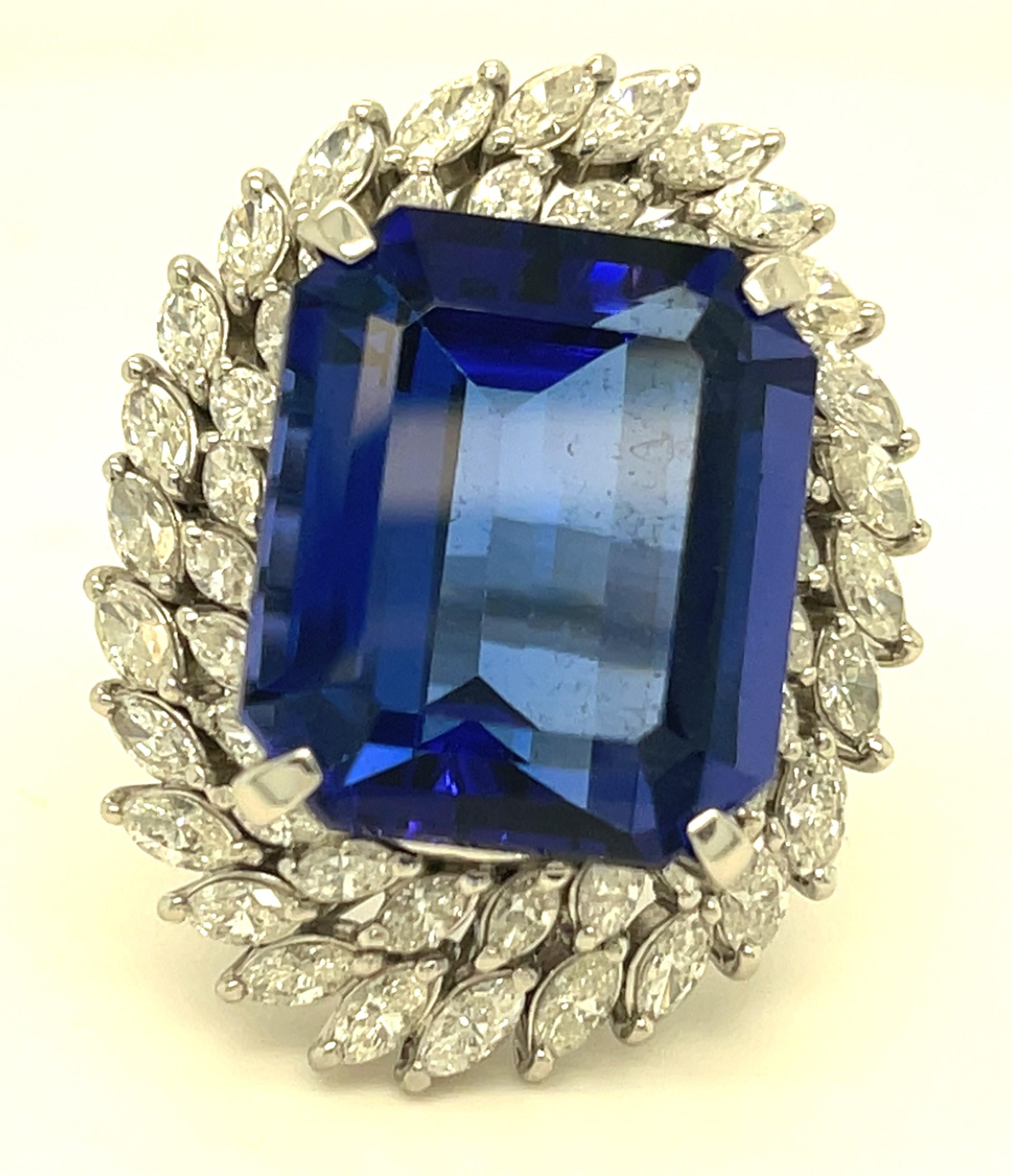 Gorgeous Rectangular Cut Tanzanite Ring
Carat Weight of Tanzanite = 23.01 ct (Inscribed in Band)
Features Double-Row of Prong-Set Marquise Diamond Bezel
Total Diamond Weight = 3.76 ct (Inscribed in Band)
Band width at reverse = 4 mm
Total Mass =