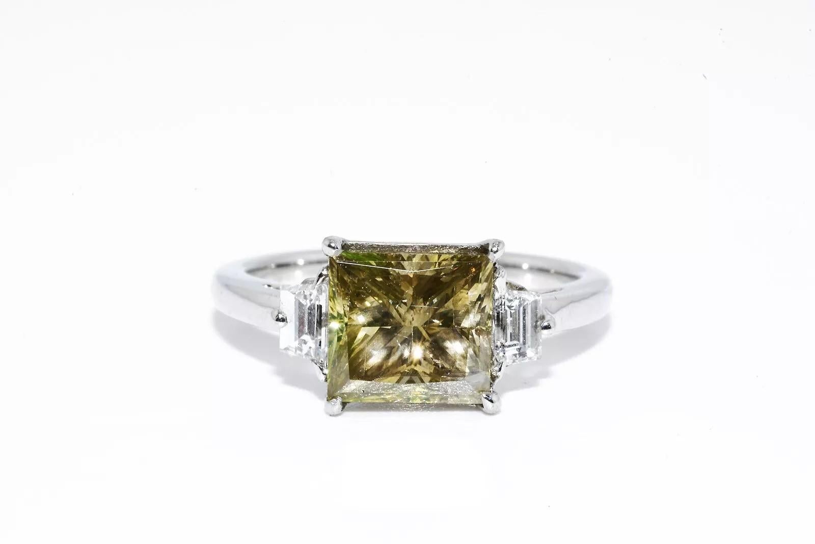 Natural Center Cognac Diamond: 2.05cts

Color: Cognac        Clarity: SI

Total # Of Stones: 1    Cut: Square Radiant

Natural Side Trapezoid Cut Diamonds: 0.31 cts.

Color: F       Clarity: VS2

Total # Of Stones: 2    Cut: Trapezoid

Type of