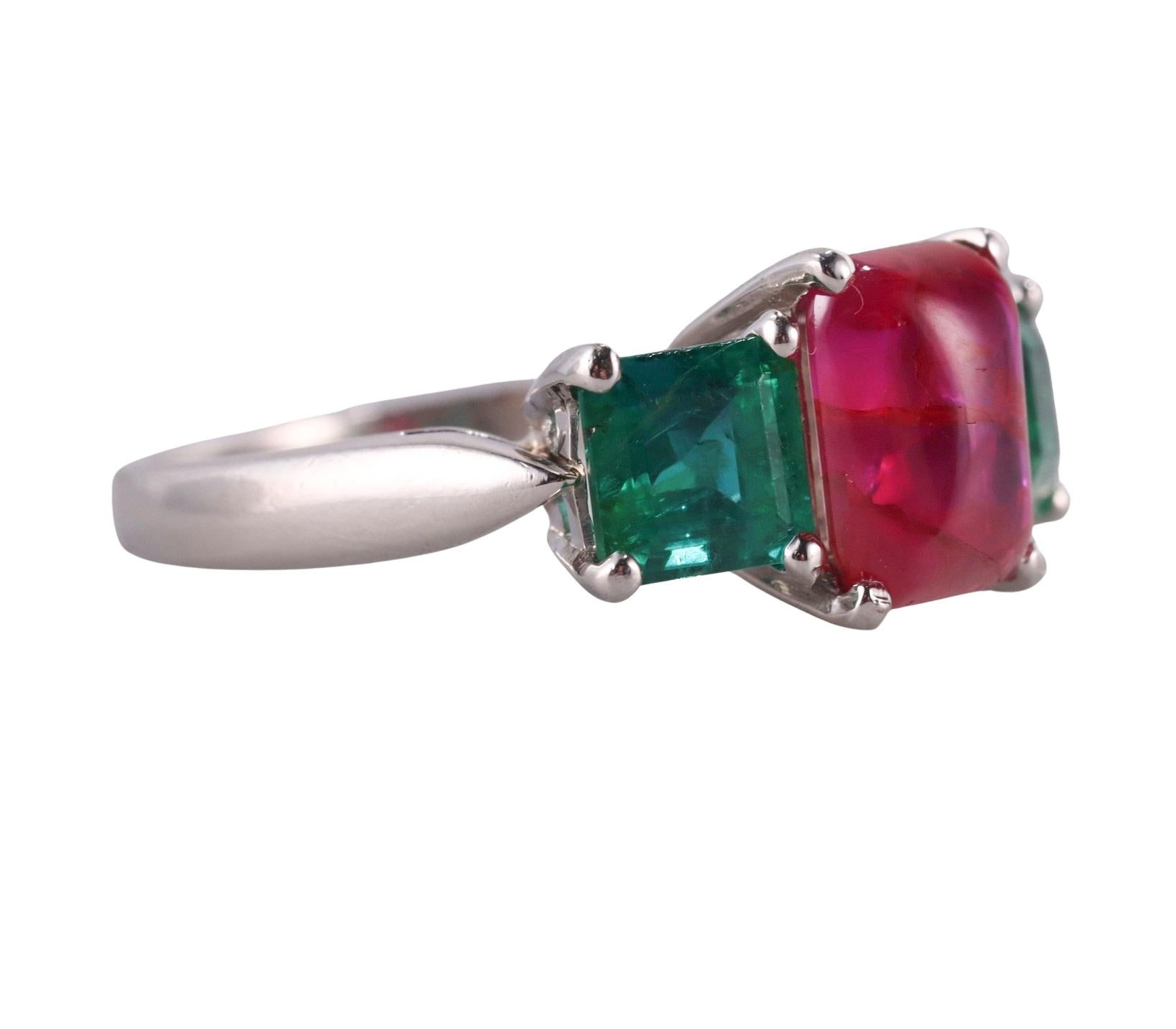 Classic three stone ring set in platinum, with center approx. 2.40ct ruby ( stone measures approx. 8.25 x 6.1mm), and two side emeralds - approx. 5.2 x 4.2mm each, 0.75ct each. Ring size 5.5. Marked plat. Weight of the ring - 5.9 grams.  Emeralds