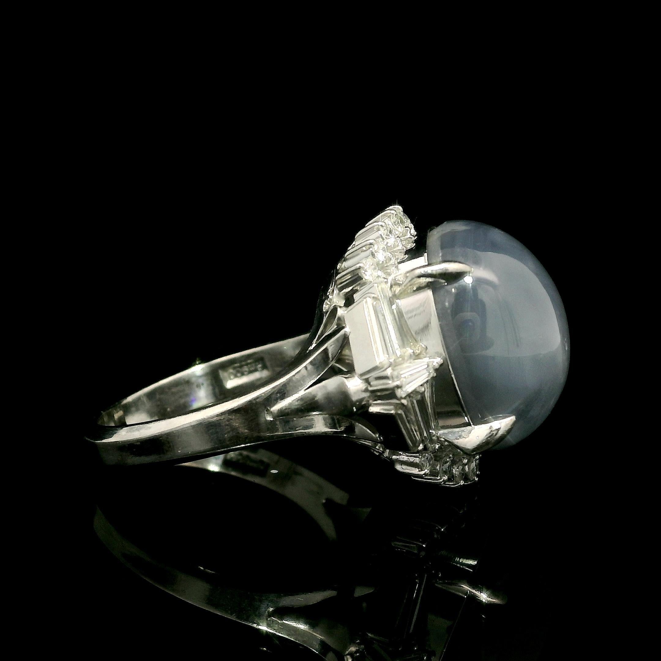 ** Very Unique Mounting **
--Stone(s):--
(1) Natural Genuine Star Sapphire - Large Oval Cabochon Cut - Prong Set - Nice Star - Grayish Blue Color - 15.2x13.1mm - 23.74ct (exact)
Natural Genuine Diamonds - 10 Baguette Cut w/ 16 Round Brilliant Cut -
