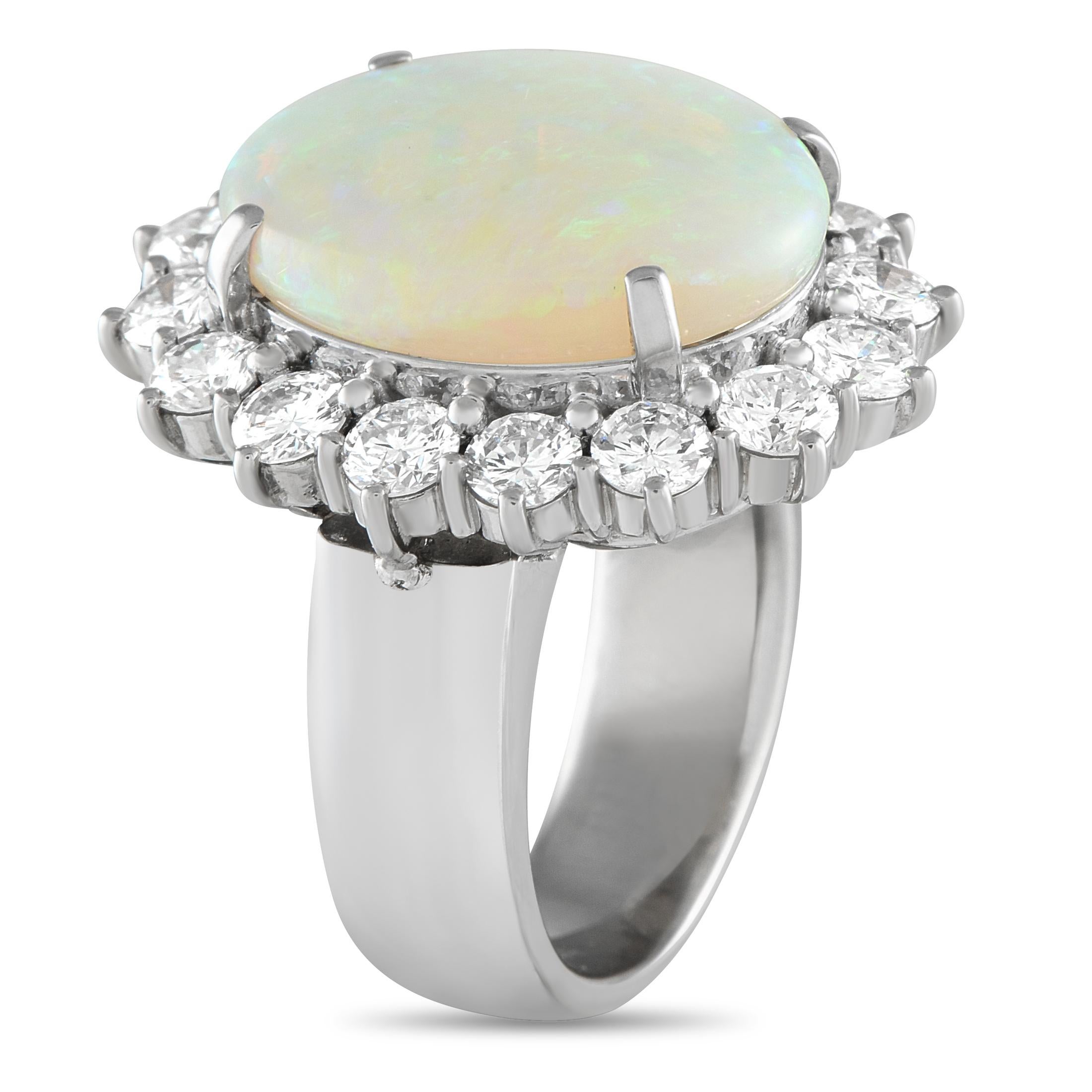 This diamond and opal ring captivates effortlessly, glowing even more beautifully as it catches the light. The ring is masterfully forged in platinum and topped with a dazzling 7.69 ct opal. The oval gemstone that showcases ripples of color is