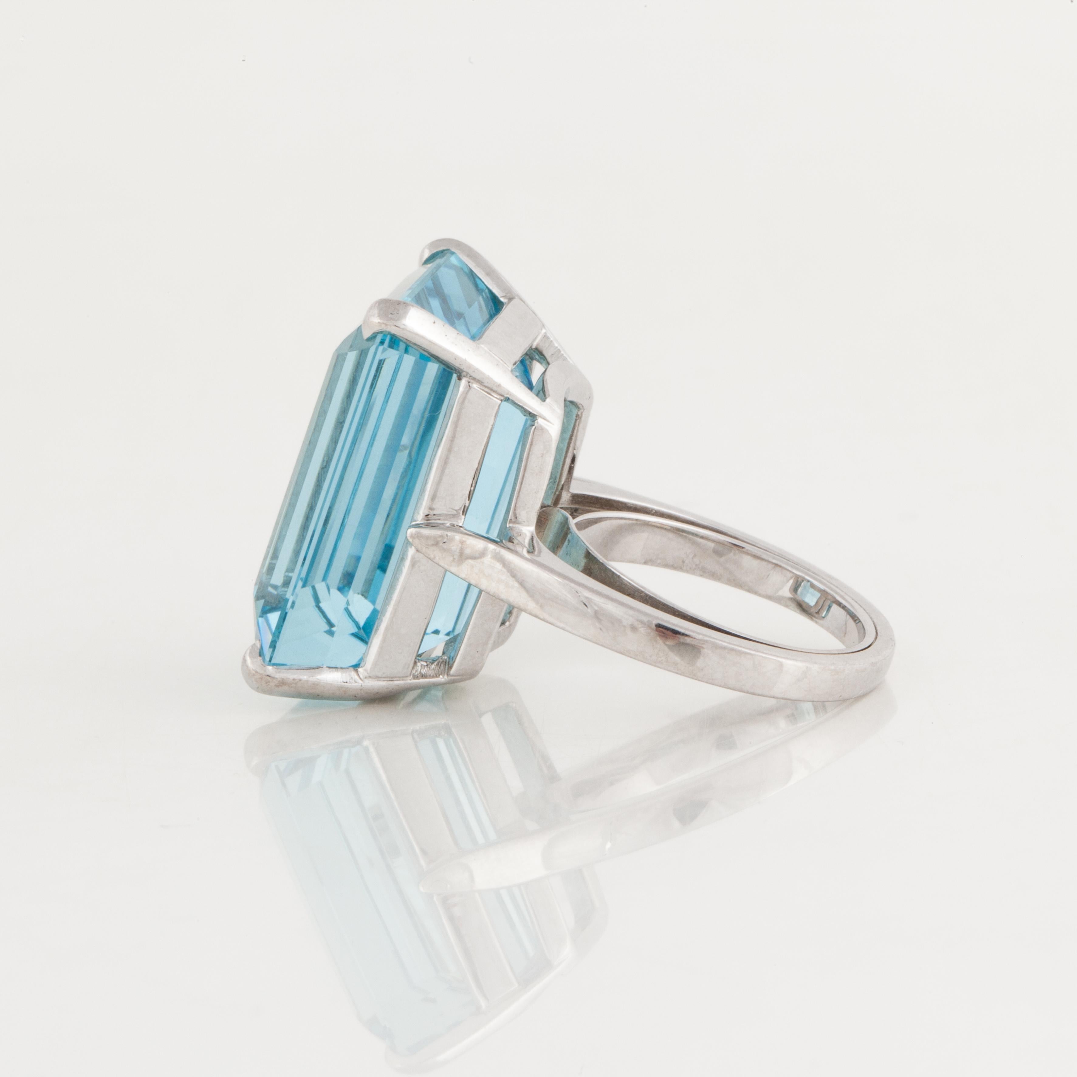 25.13 carat step-cut aquamarine ring in a simple basket mounting done in platinum. The ring measures 11/16 inches long and 3/4 inches wide, and stands 3/8 inches off the finger. 