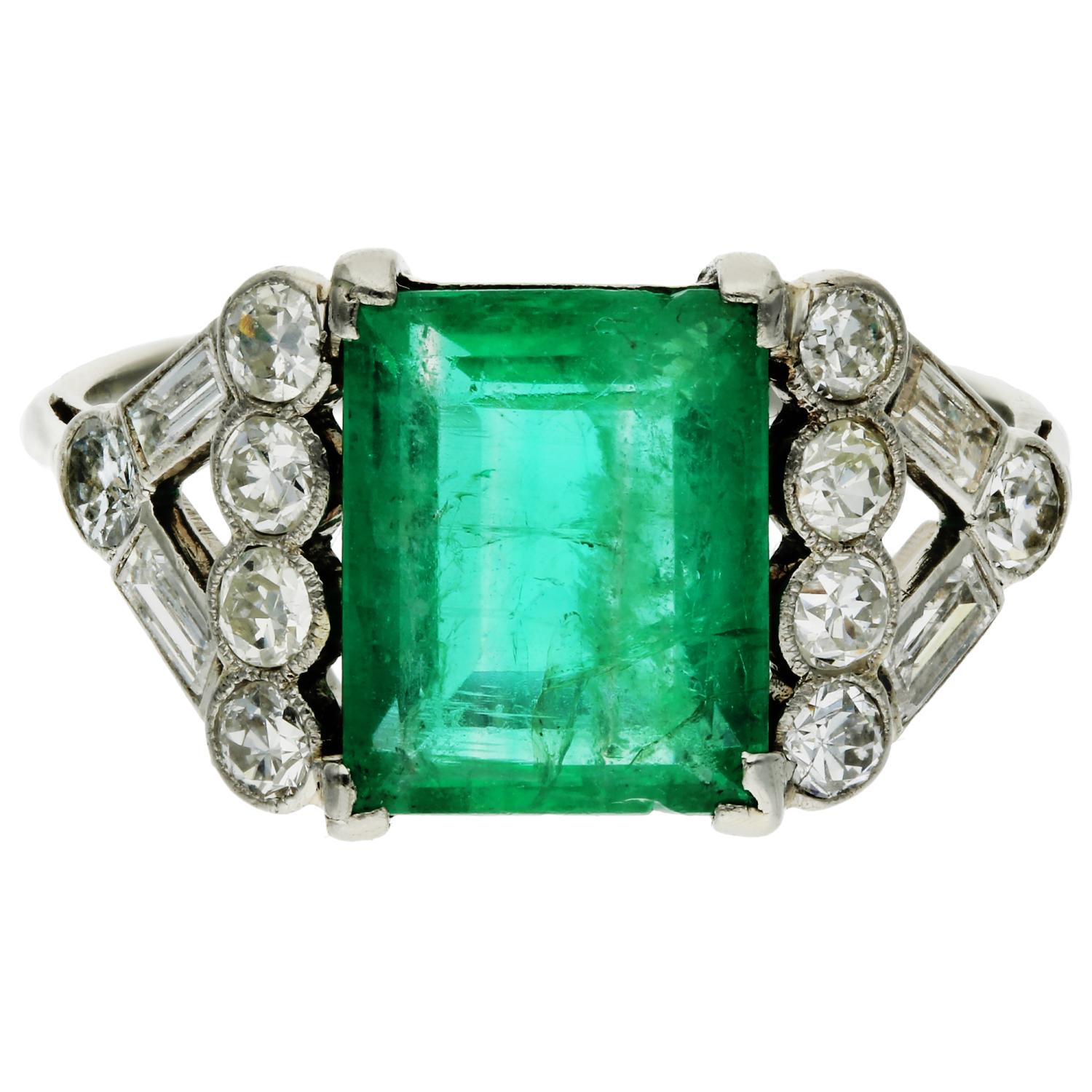 Platinum 2.65ct Emerald & 0.70ct Diamond Dress Ring

Indulge in sophistication with our Pre-loved Platinum Emerald & Diamond Ring, a captivating ensemble that effortlessly combines vintage charm with timeless elegance.

The ring features a