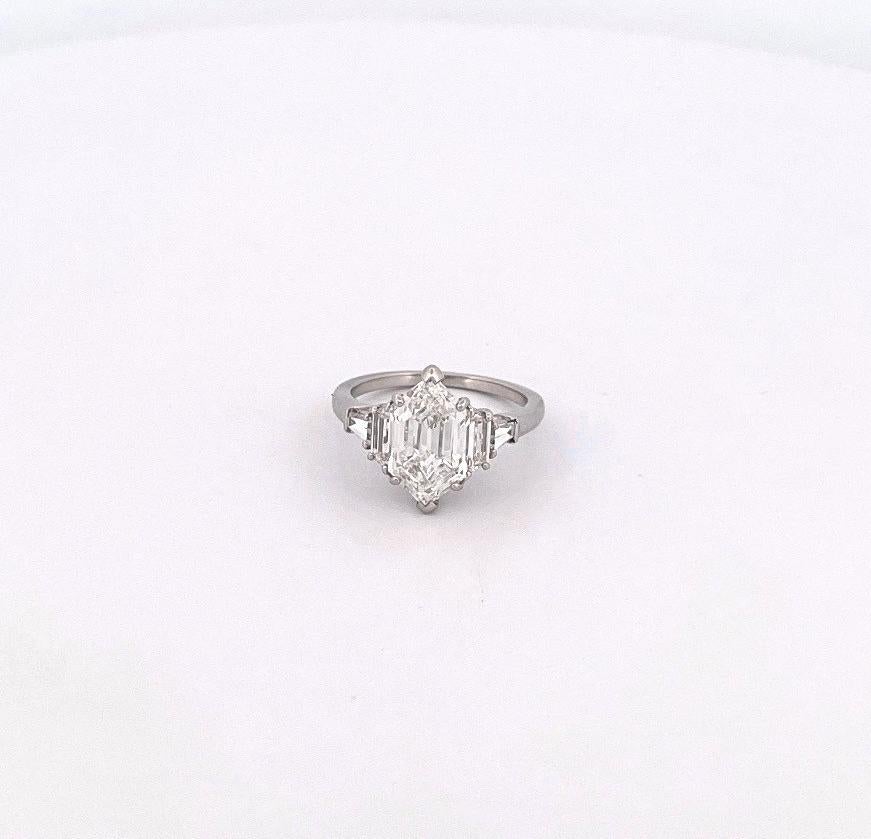 From the Eiseman Estate Jewelry Collection, this unique platinum 5-stone engagement ring showcases a GIA certified 2.87 carat modified hexagon step cut diamond with E coloring and VVS2 clarity. Paired with the center stone are two trapezoid diamonds