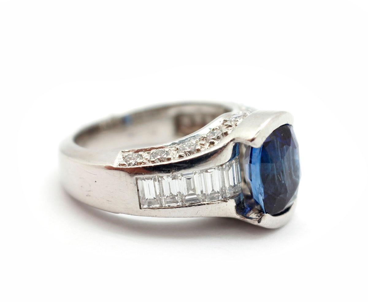 Absolutely dazzling! This ring features an oval cut sapphire set into platinum. The sapphire weighs 2.98 carat. The ring is then set with round and baguette-cut diamonds for an additional weight of 1.40 carats. The ring measures 11mm wide, and it