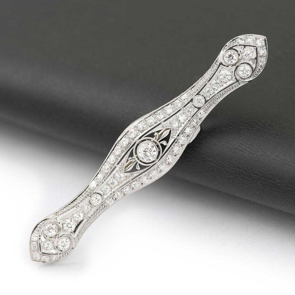 A really lovely early 20th century long bar brooch made in the shape of a propeller. Superb crafted in platinum with a combination of pave set Old European and small round cut diamonds, all the gems are mille-grain set. The estimated diamond content