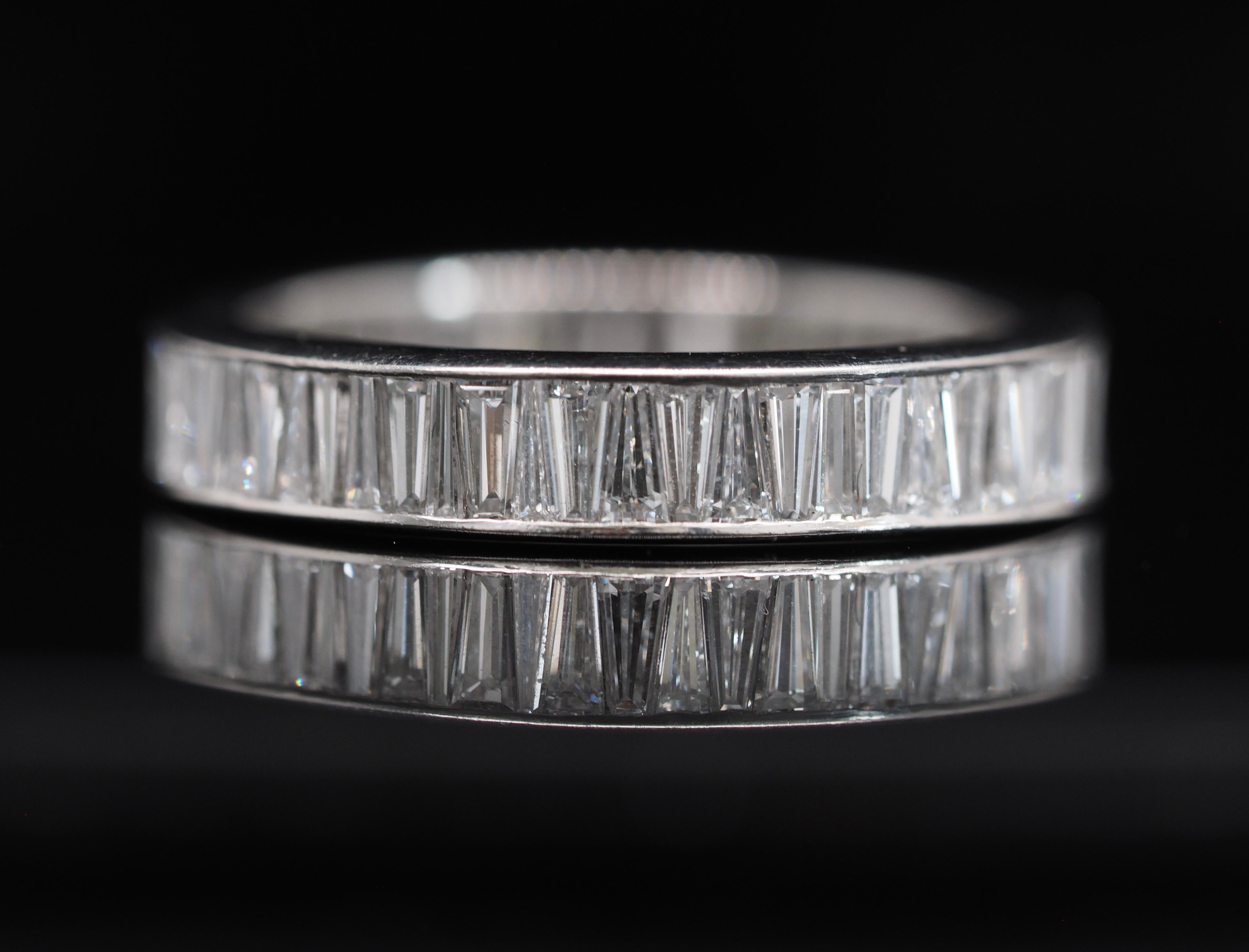 Platinum 3 Carat Tapered Baguette Eternity Band. The tapered baguette diamonds alternate up and down fitting like a puzzle right next to each other. It is a one of a kind band! Excellent condition! 

Size: 10n ( cannot be sized)
Metal: