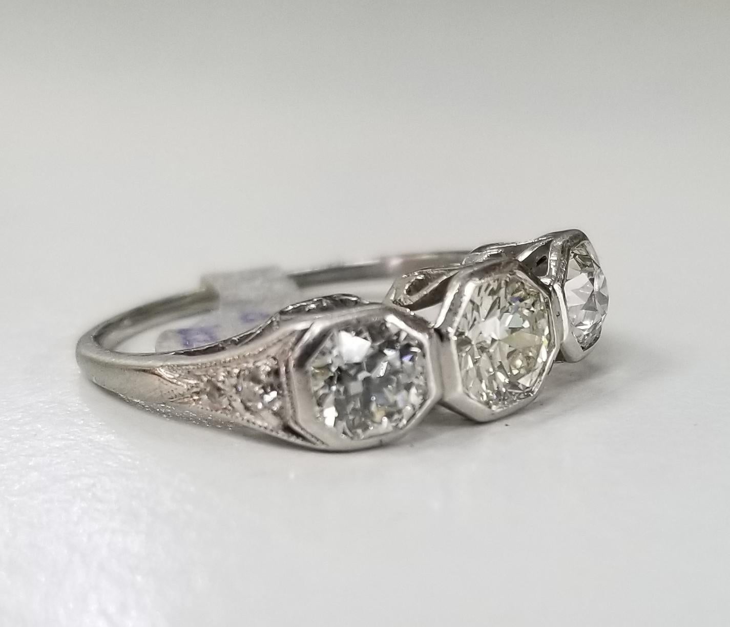 Platinum 3 diamond vintage ring, containing 3 round Euro cut diamonds of very fine quality weighing 1.75cts.  The center diamond; color 