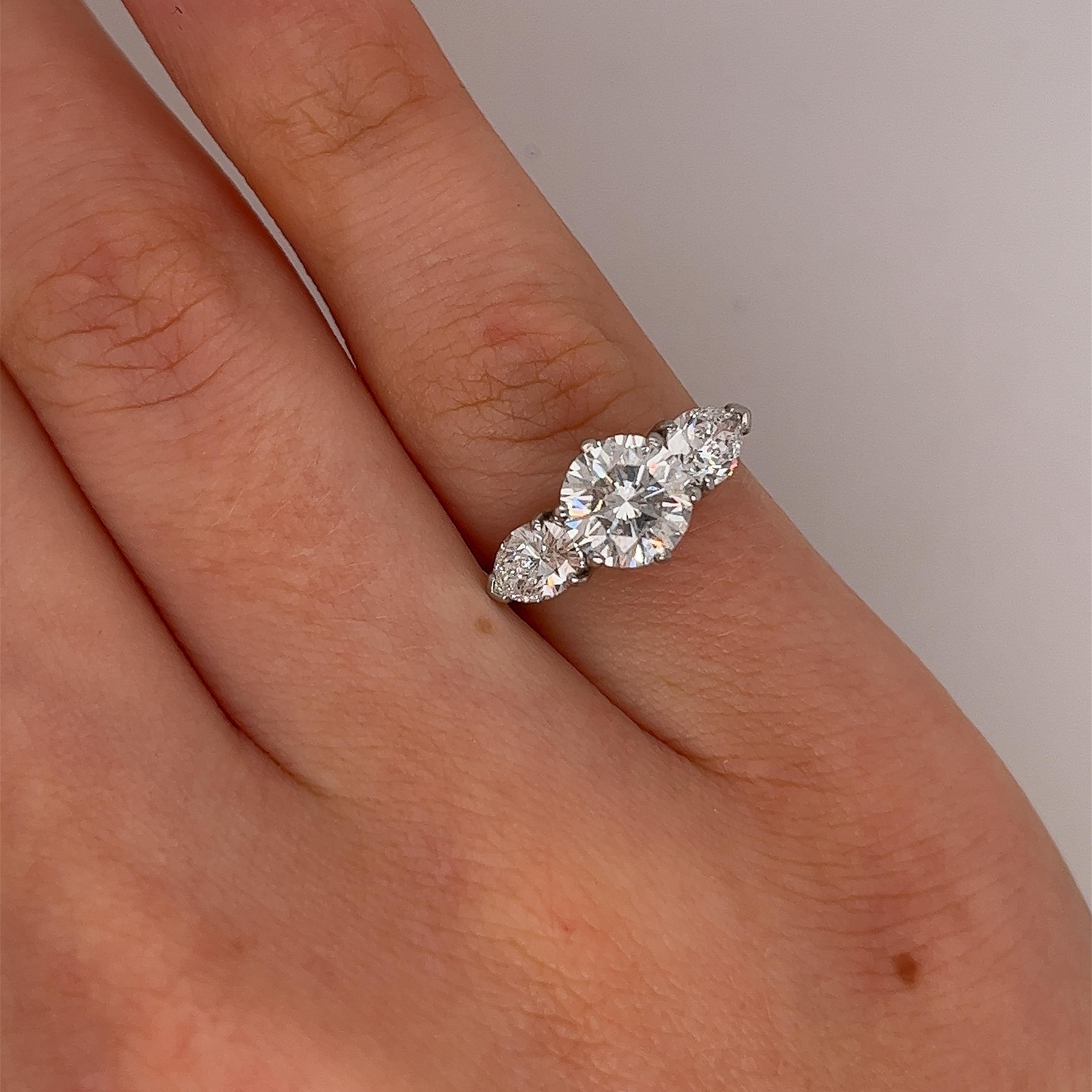 Platinum 3-stone diamond ring set with 1 round brilliant cut GIA certified 1.29ct G/SI1 and 2 matching pear shape diamonds 0.85ct.
This ring is elegant and beautiful for an engagement ring and will last as long as your love does.

·  Total Diamond