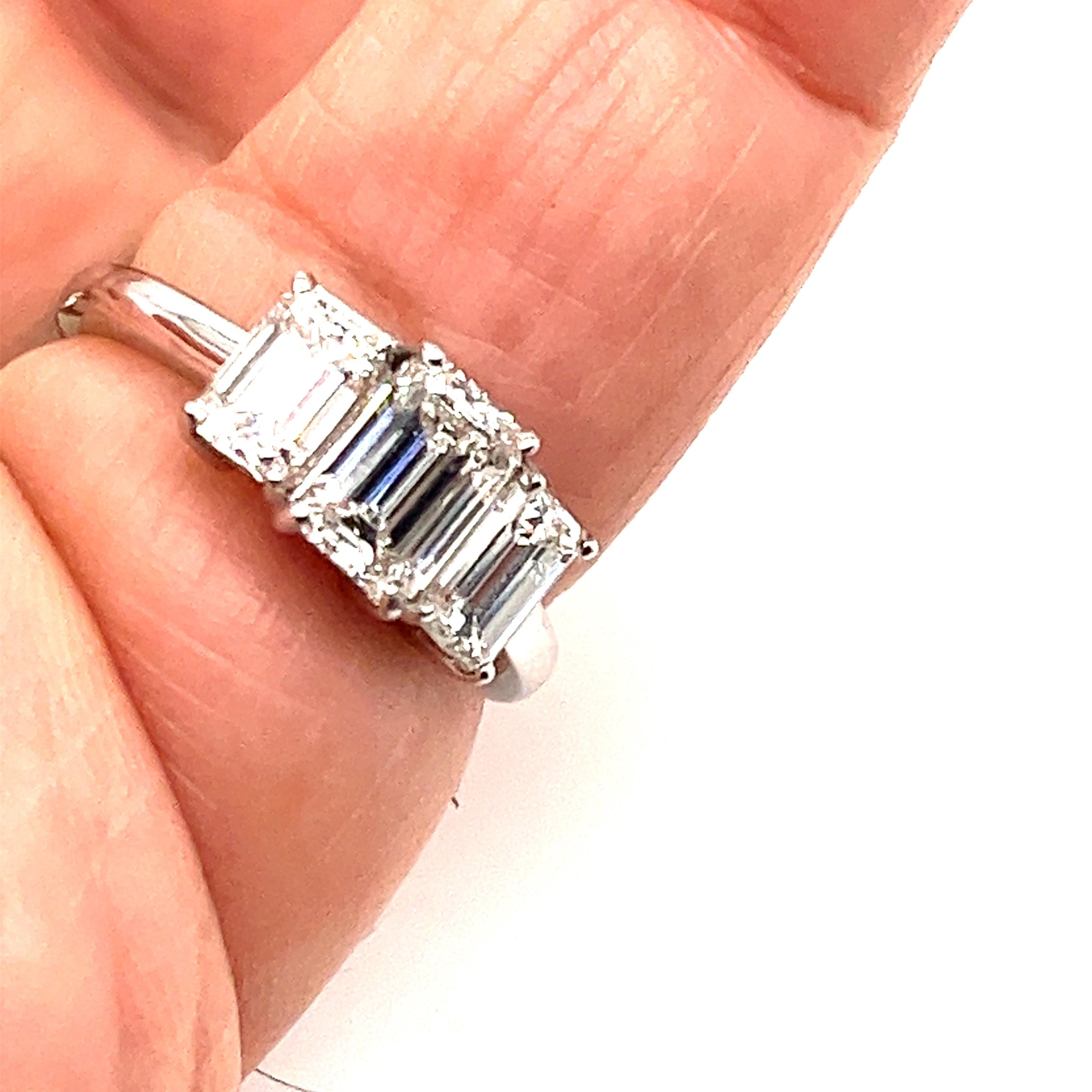 Offered here is an elegant three stones ring, handmade in noble 950 platinum.
Centered with a 1.01 ct natural earth mined Emerald cut diamond flanked with a natural earth mined Emerald cut diamond on each side of the shank, side stones weight is