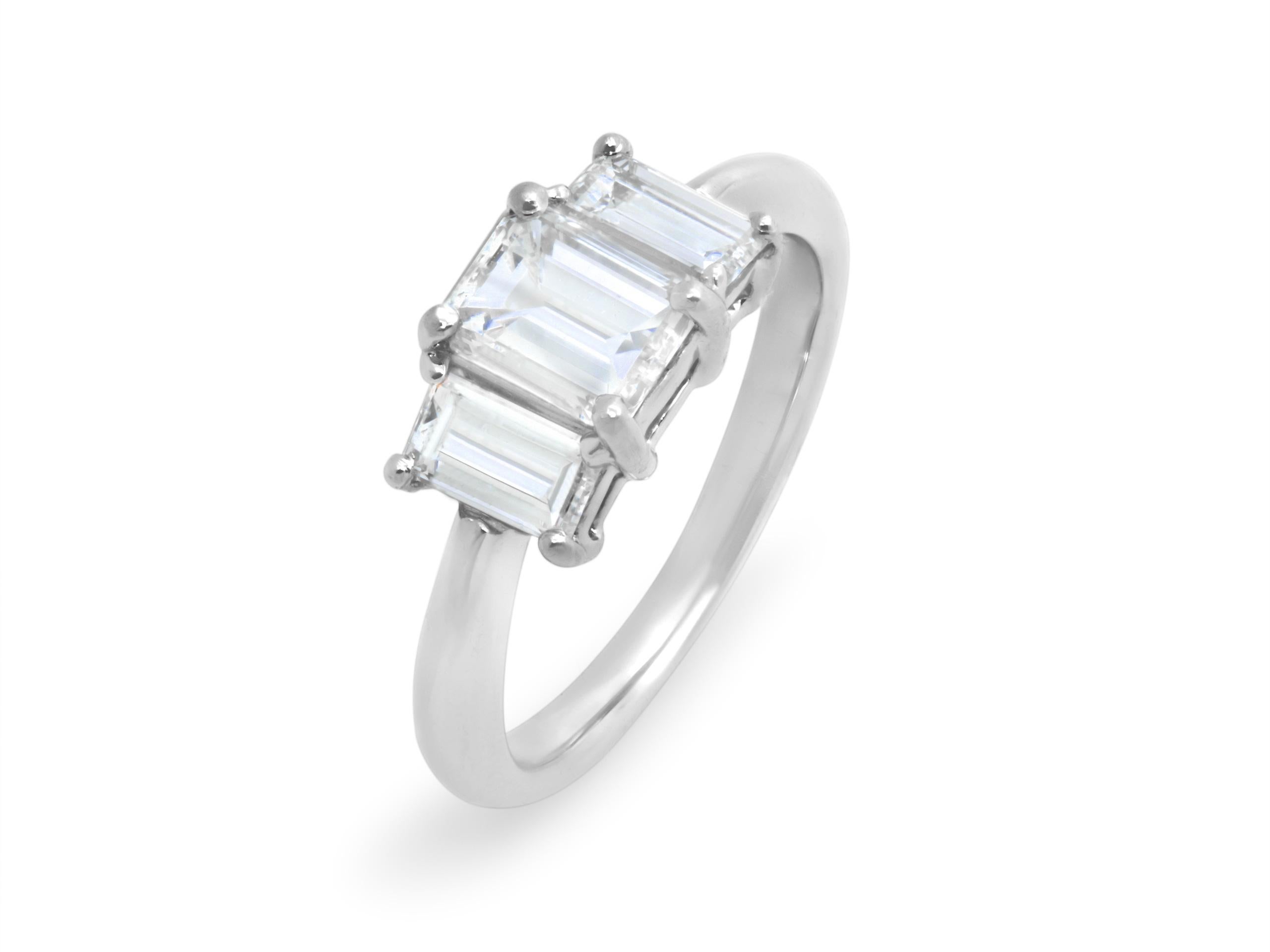 A classic platinum three-stone diamond ring, featuring a 1.00ct center diamond (GIA H, VS2), accented by 0.42ct (GIA E, SI1) and 0.41ct (GIA F, SI1) side diamonds. 