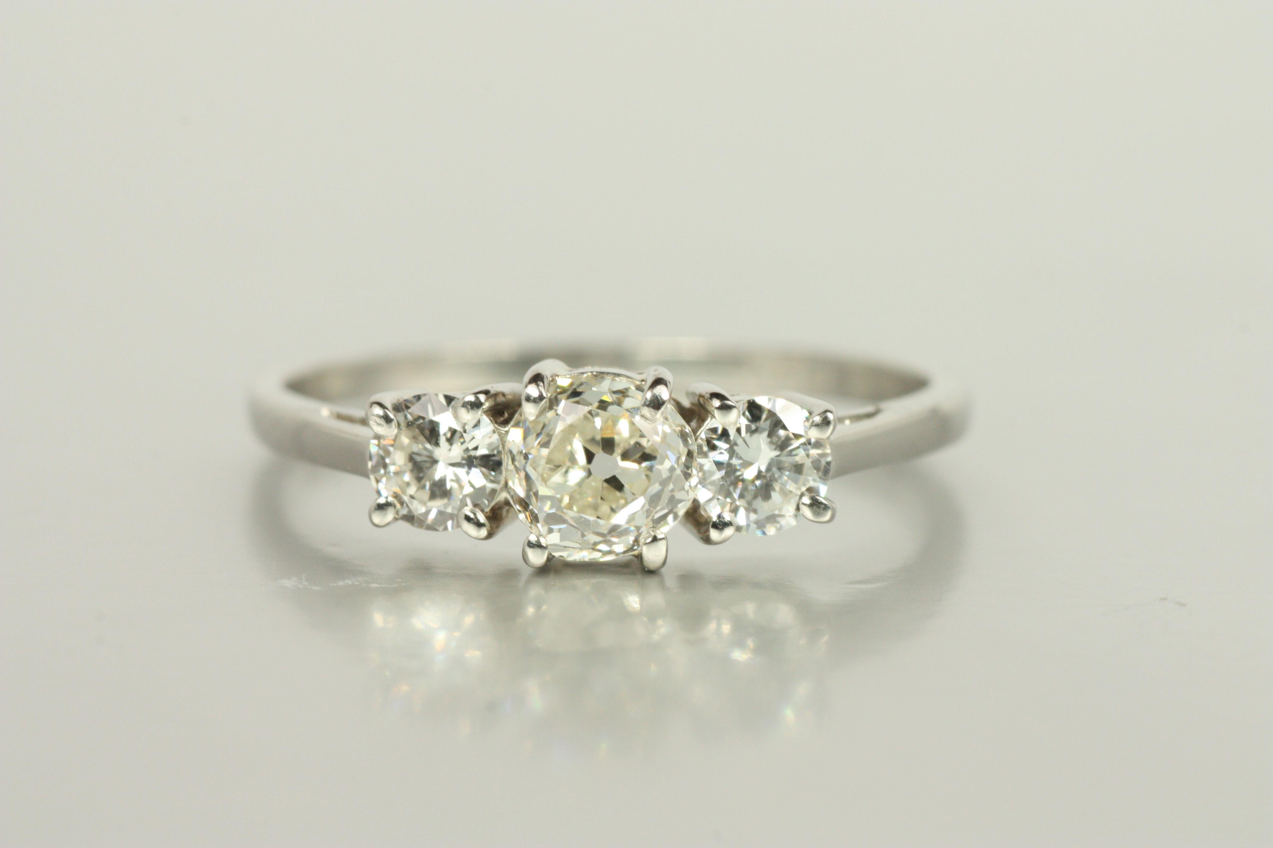 A romantic nod to the past, this three-stone engagement ring centers a 0.48ct old mine cut diamond (VS2, J), accented by 0.30cttw of round brilliant-cut side stones. Crafted in platinum with elegant proportions, it radiates both heritage and light.