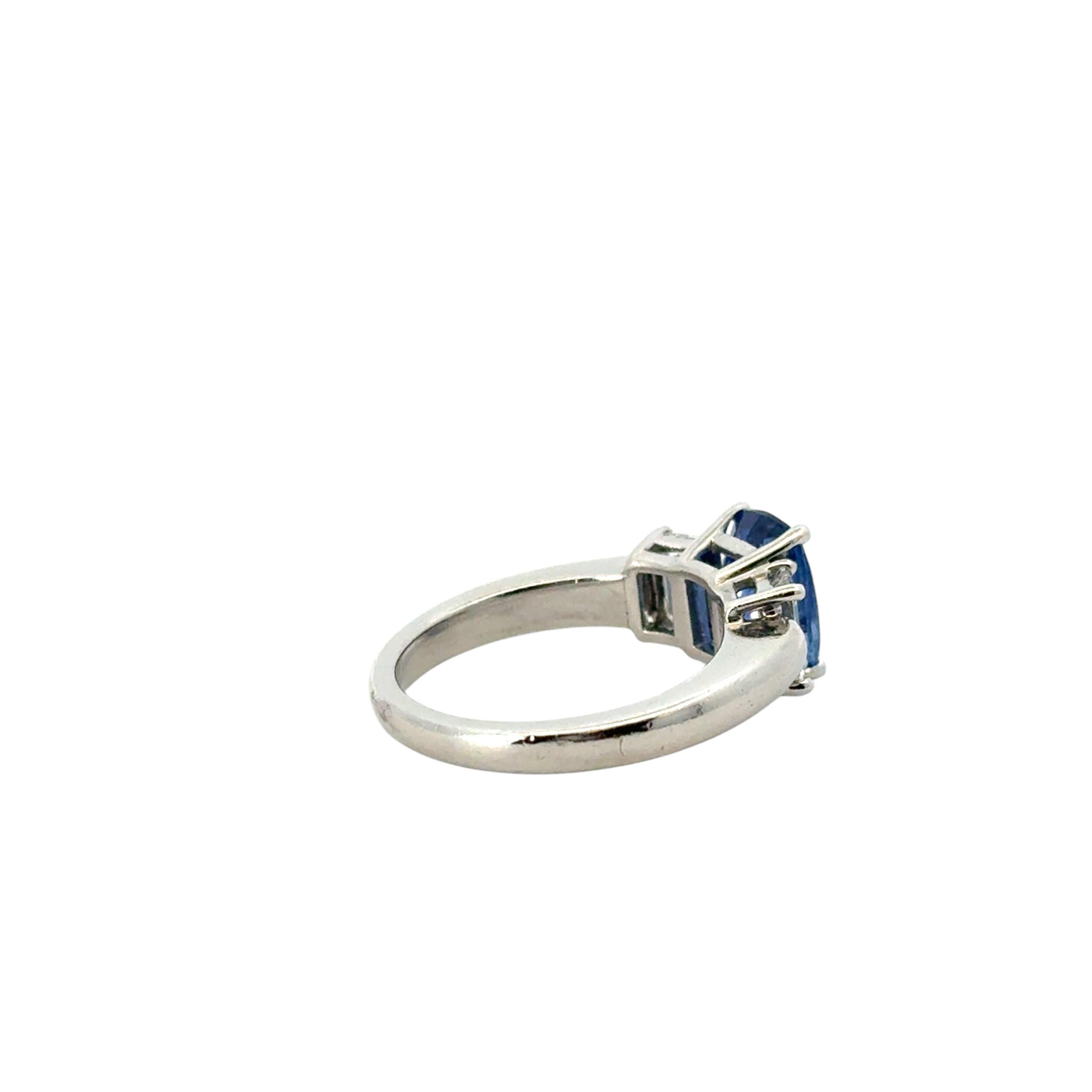 Women's Platinum 3 Stone Ring set with Natural Cushion Blue Sapphire and Side Diamonds For Sale