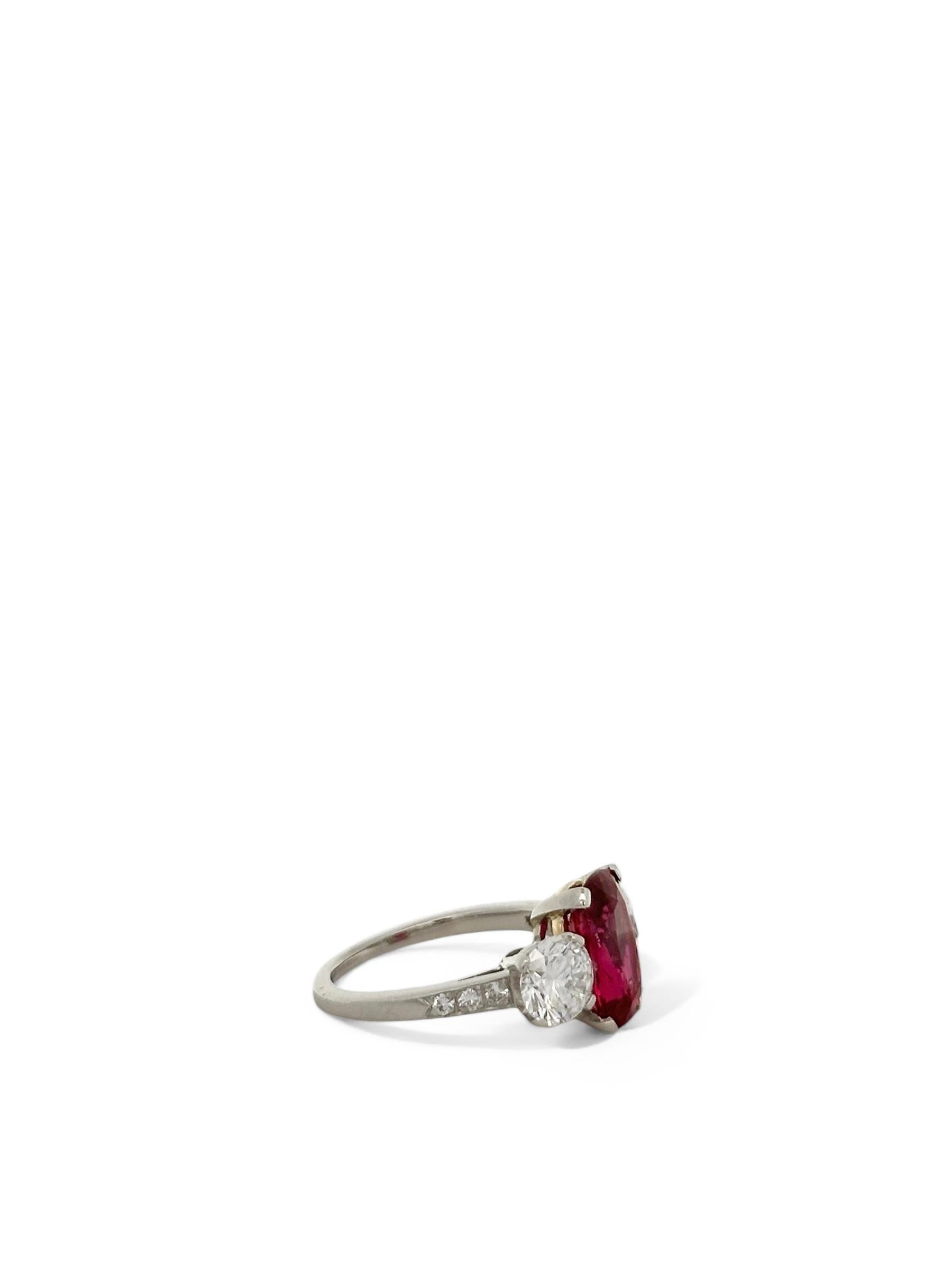This exquisite platinum ring features a 2.50-carat cushion-cut ruby at its center, exuding a deep, fiery red allure. Flanking the ruby are two round brilliant diamonds, together totaling 1.30 carats. Their dazzling sparkle beautifully contrasts the