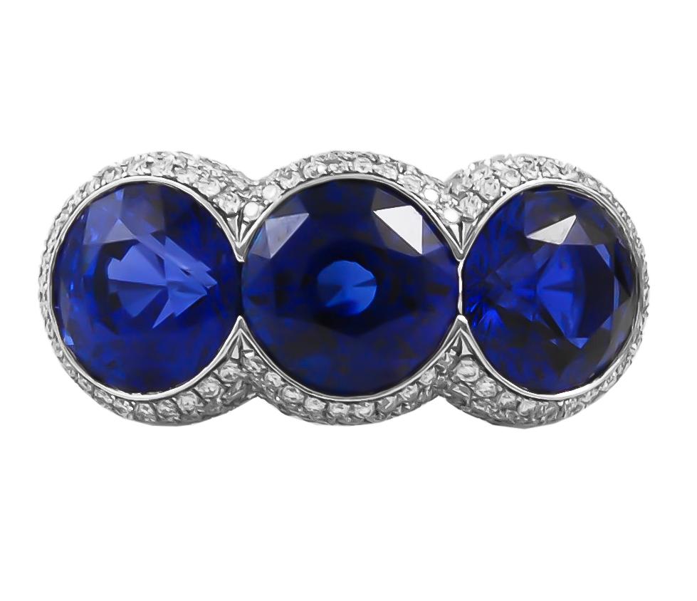 Contemporary Sapphire Diamond Three Stone Ring in Platinum.

A matching trio of intense velvet blue sapphires of similar sizes, impeccably set with white diamond pavé throughout.

Sapphire weight approx. 12.00 carats total. Diamond weight approx.