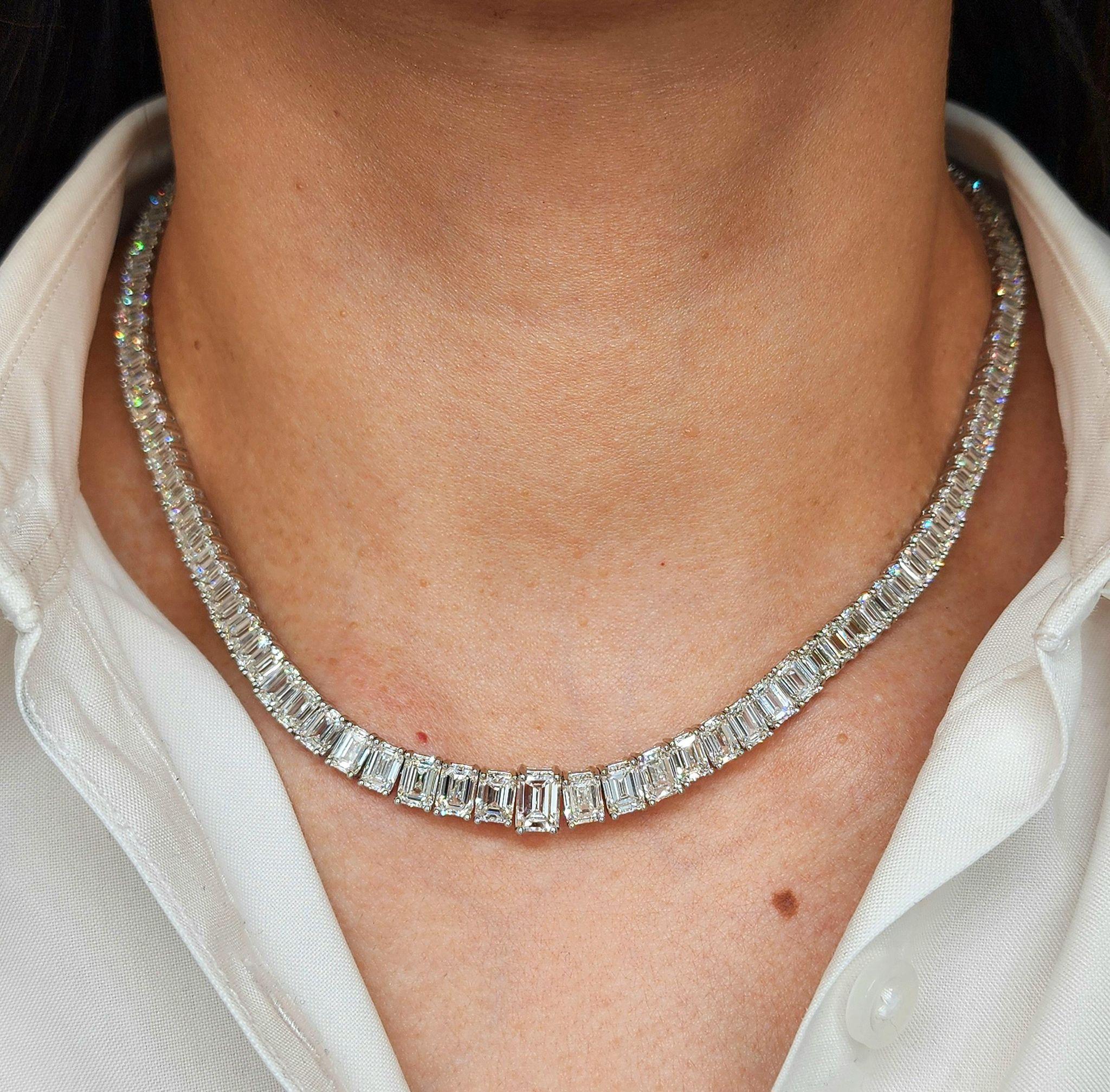 This striking platinum necklace features an impressive total of approximately 30 carats of emerald cut diamonds, meticulously selected for their brilliance and elegant step-cut facets. The center stone weighs approximately 1 carat, with a seamless