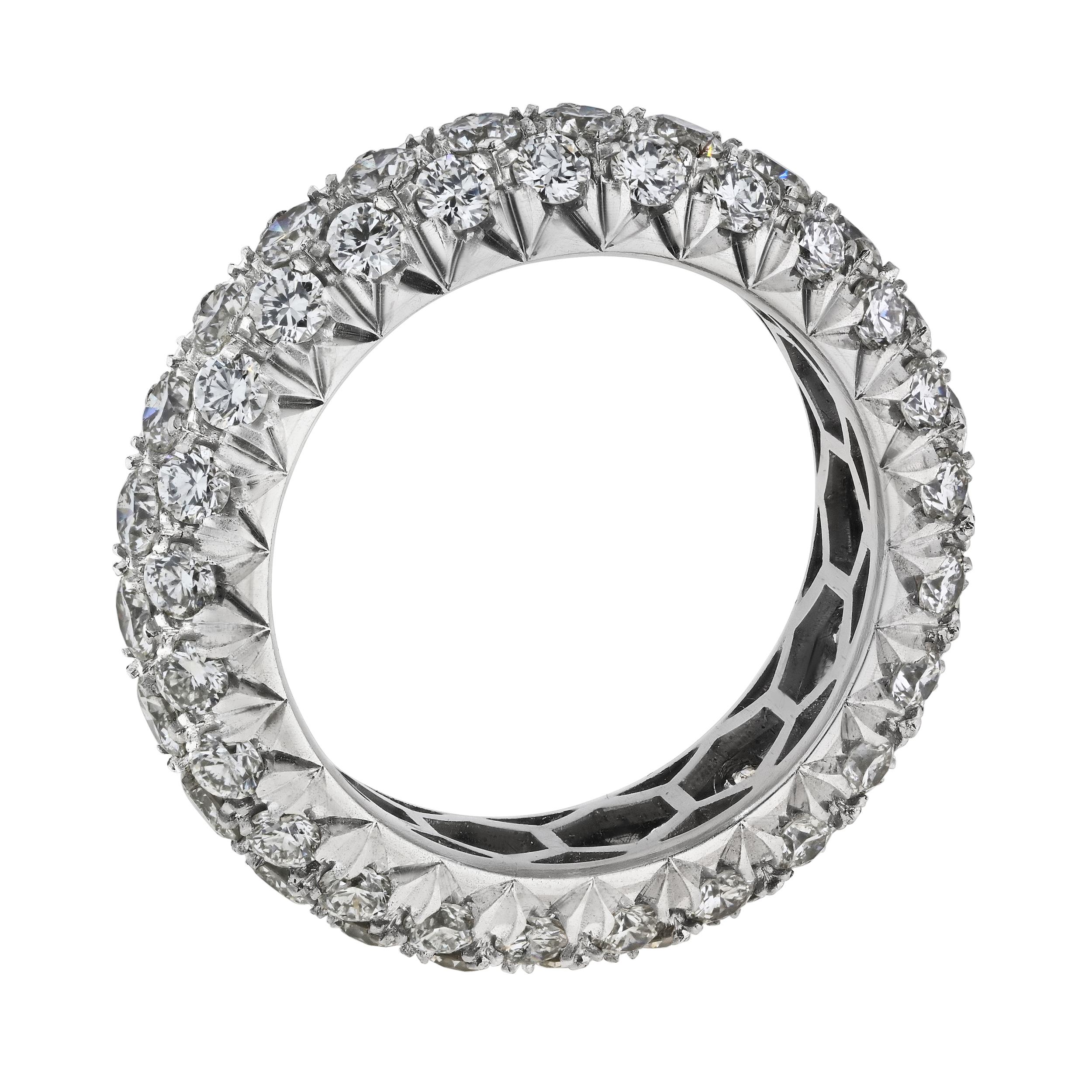Indulge in the timeless elegance of this handmade platinum diamond eternity band. Skillfully crafted, the band features three rows of round pave-set diamonds, creating a captivating multi-row design. With a width of approximately 6mm and a height of